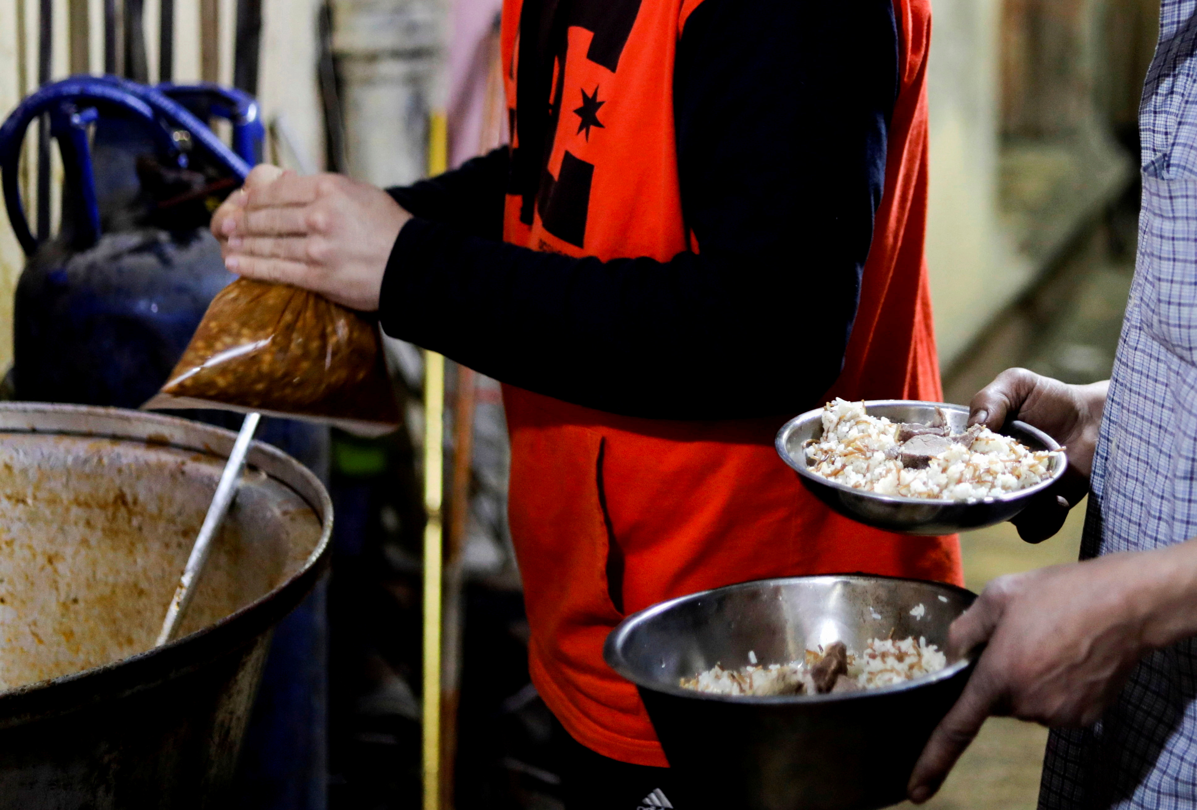 A man takes prepared food to eat during Iftar