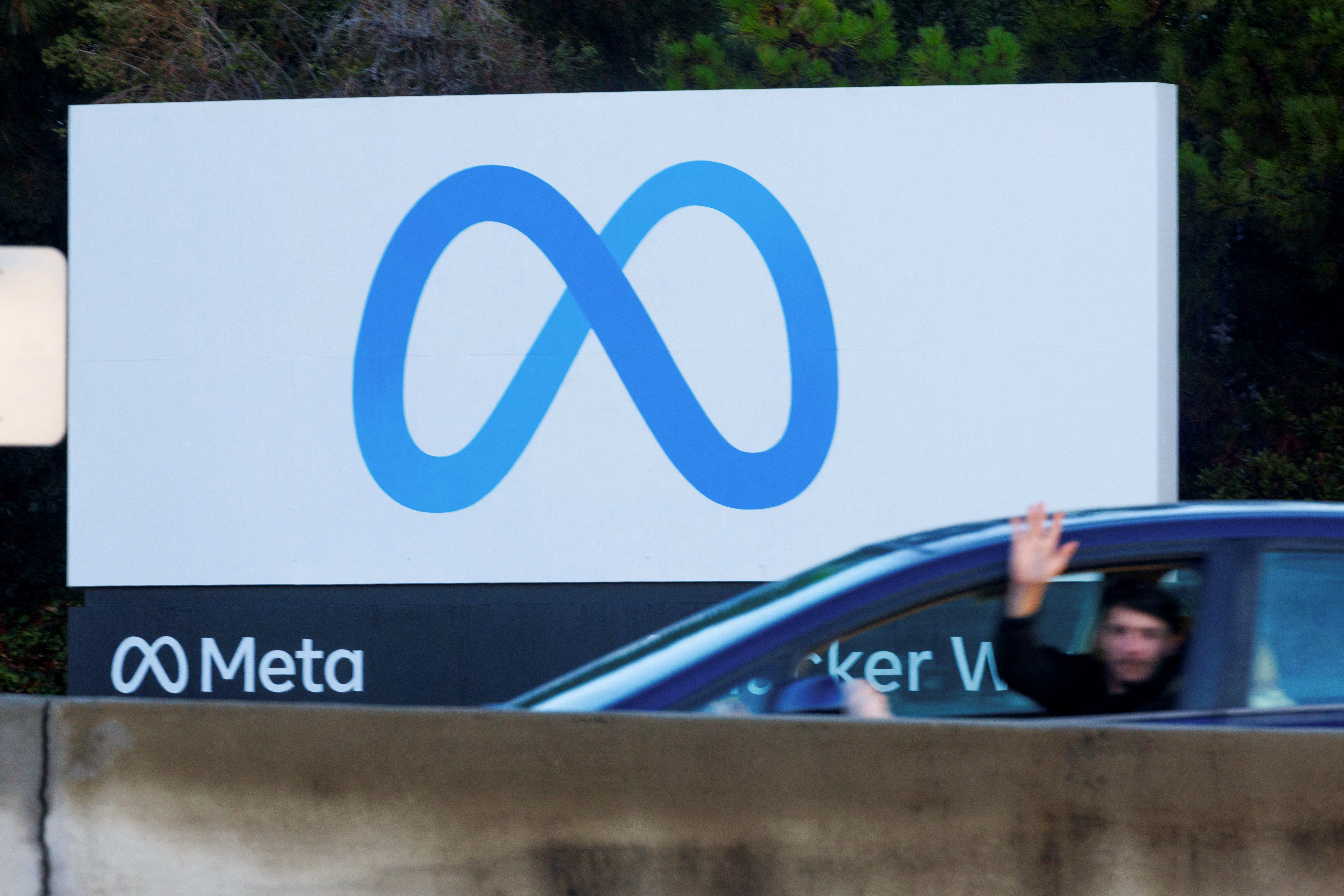 Commute traffic streams past the Meta sign outside the headquarters of Facebook parent company Meta Platforms