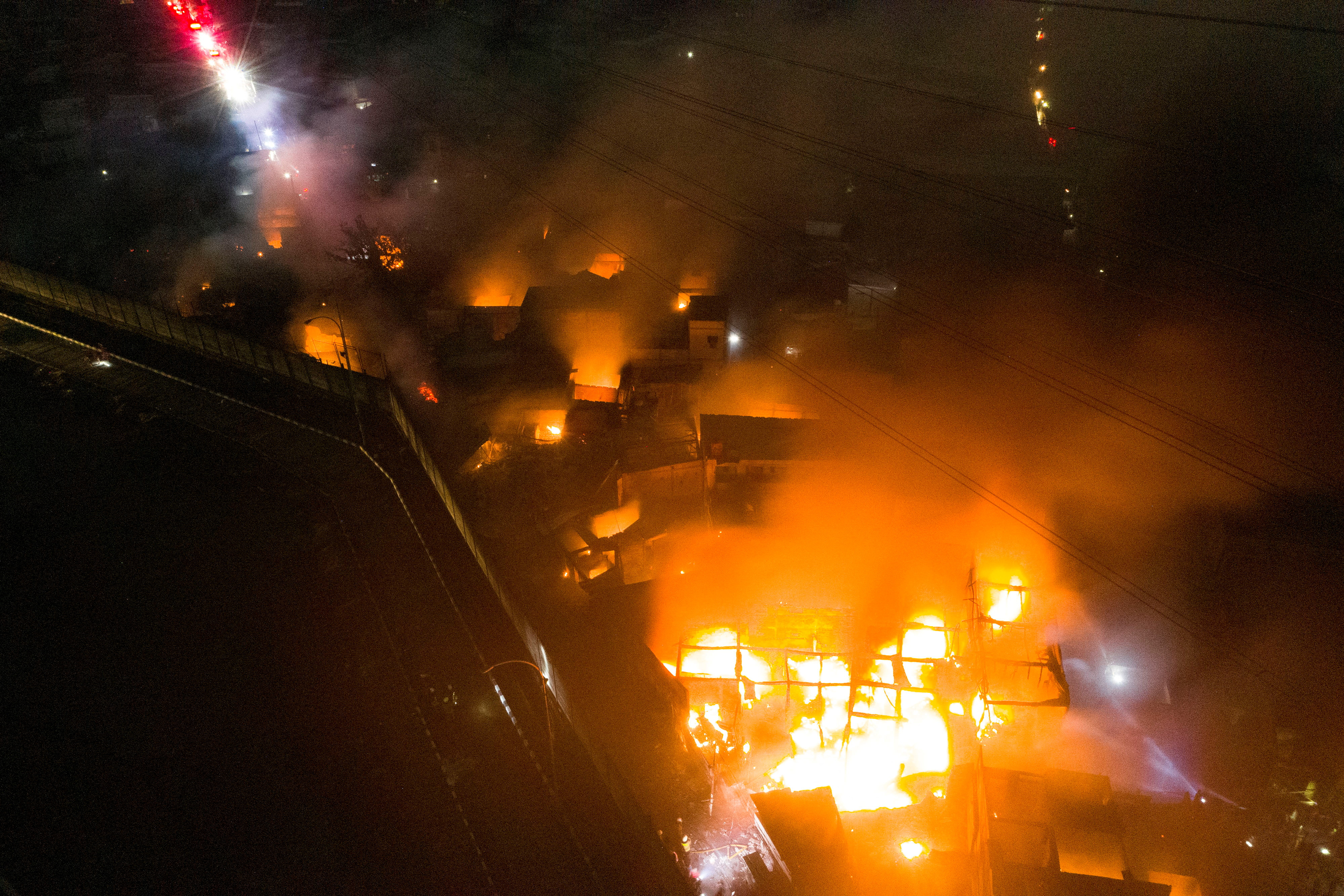 An aerial view of a residential area, after fire broke out at a fuel storage station operated by Indonesia's state energy company Pertamina