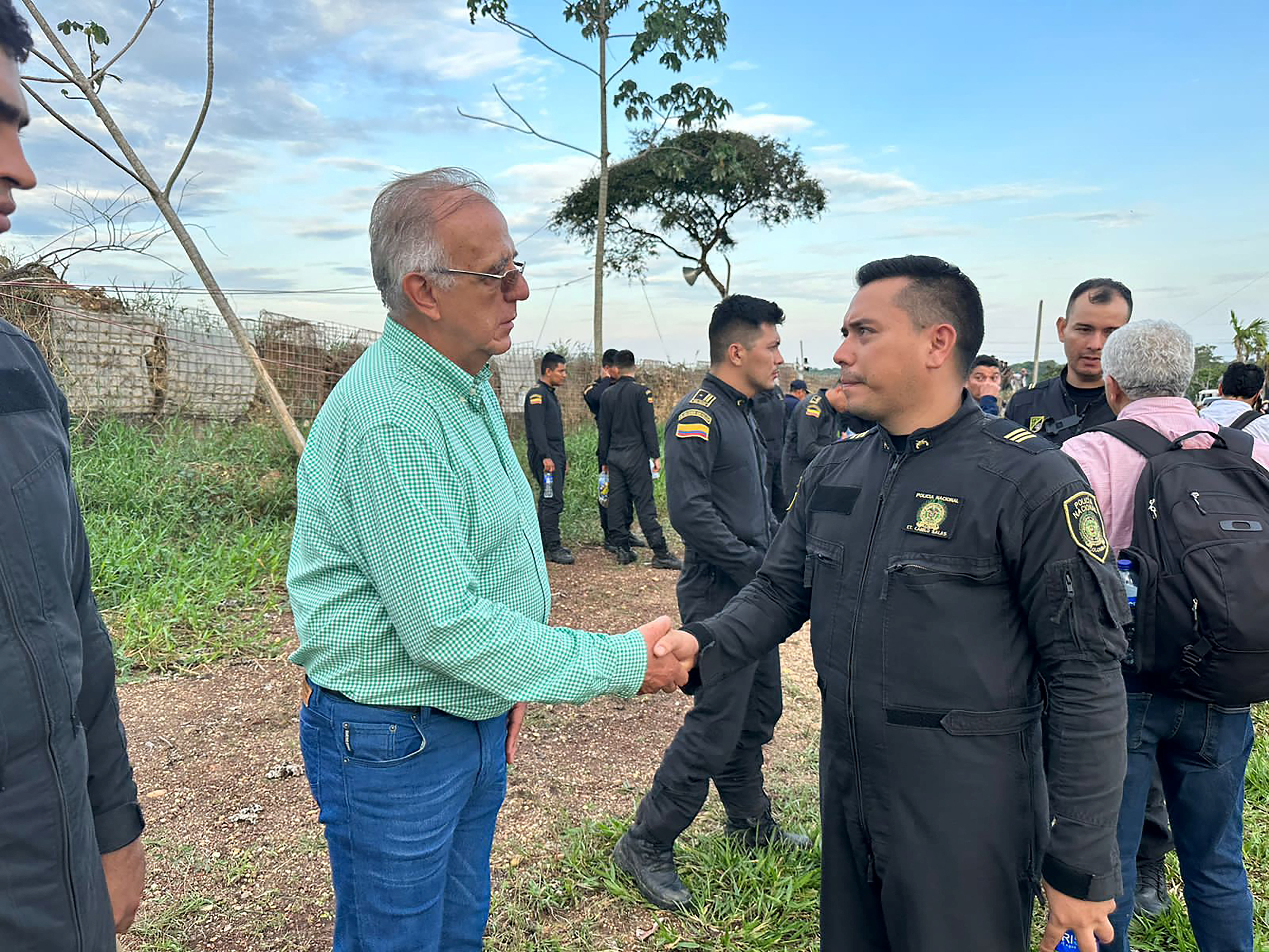 Ivan Velasquez shakes a police officer's hand