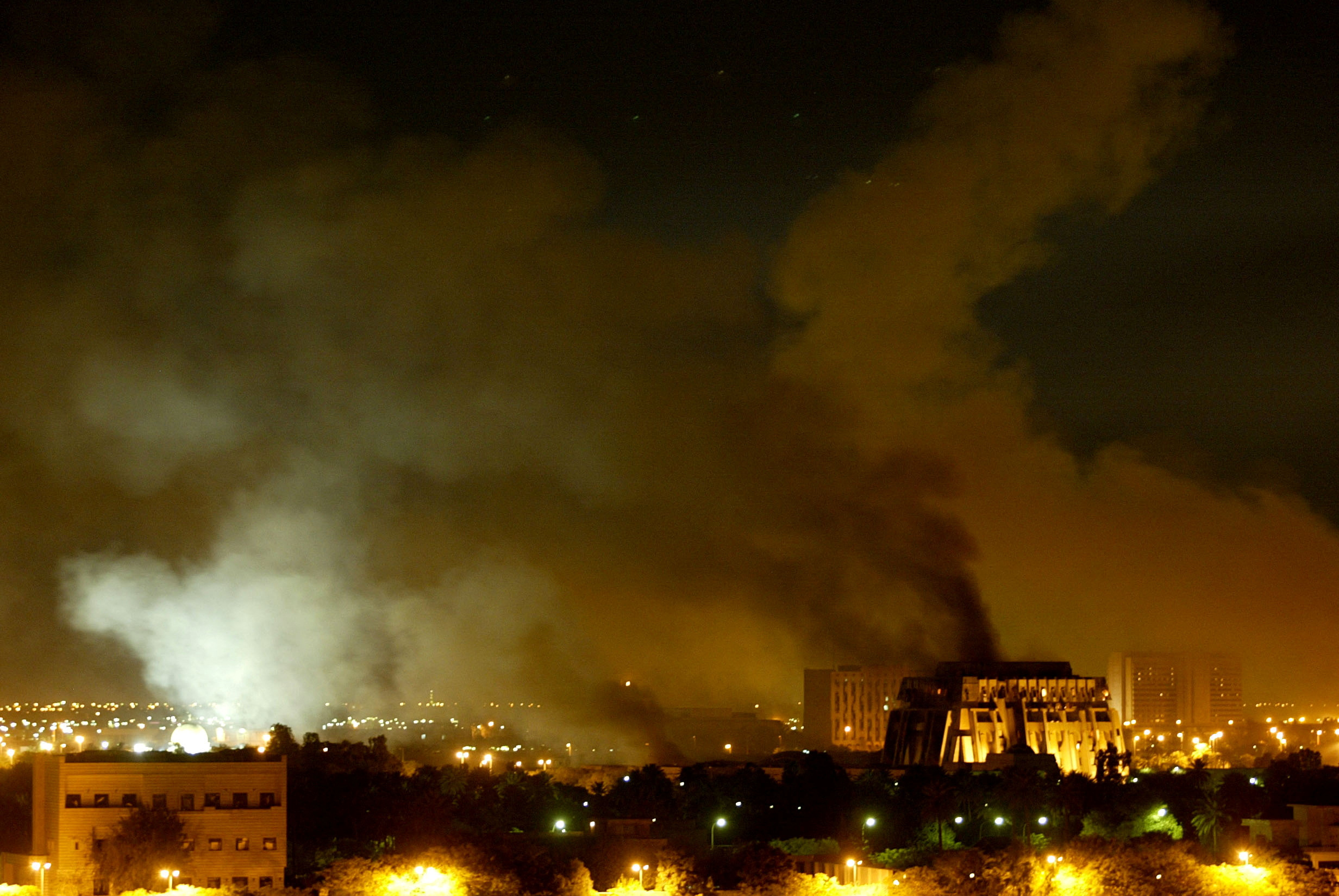 Smoke billows from a presidential palace compound in Baghdad during air strikes, Iraq March 21, 2003.