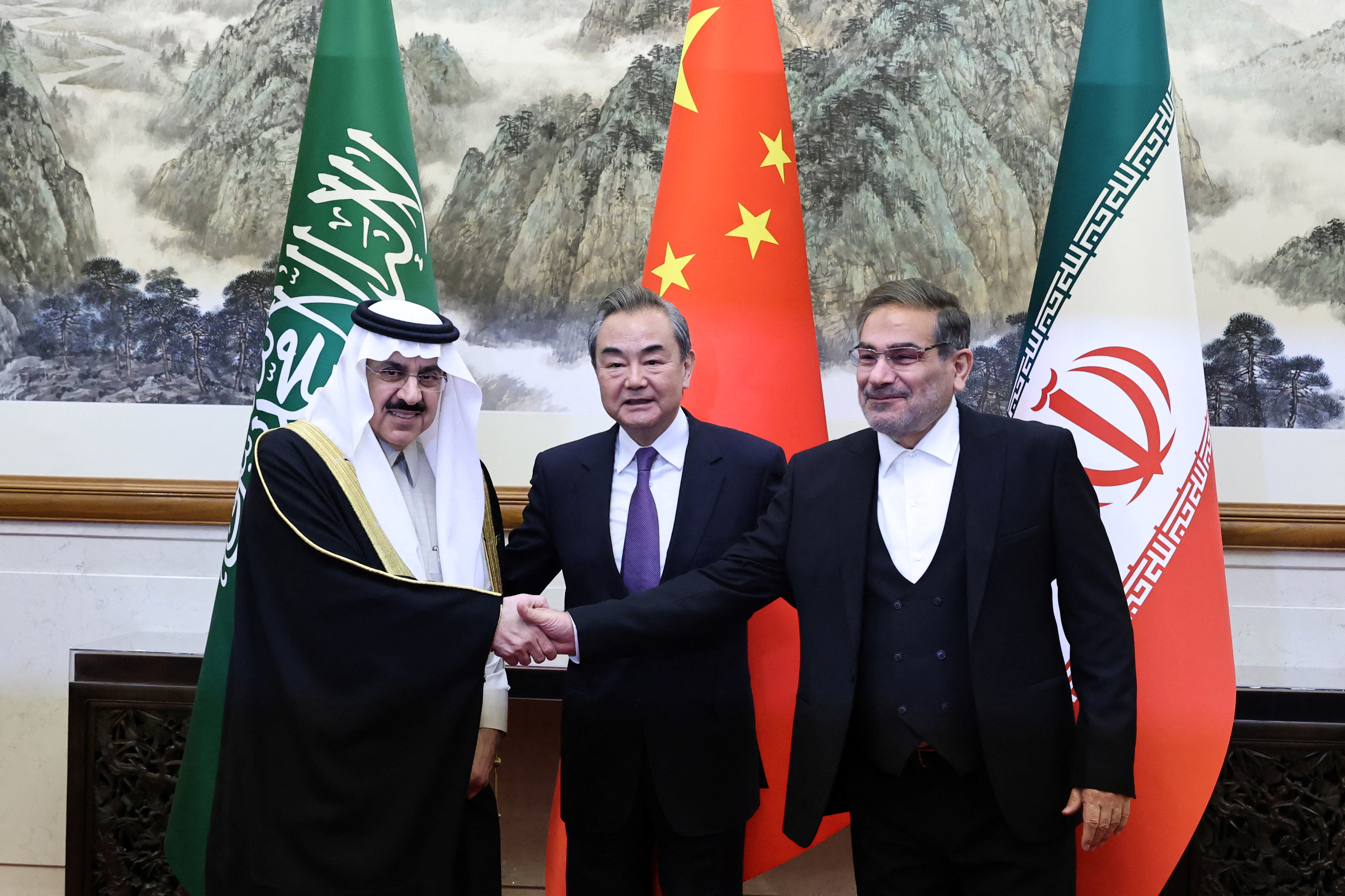 China's Wang Yi, Iran's Ali Shamkhani and Saudi Arabia's Musaad bin Mohammed Al Aiban pose for pictures