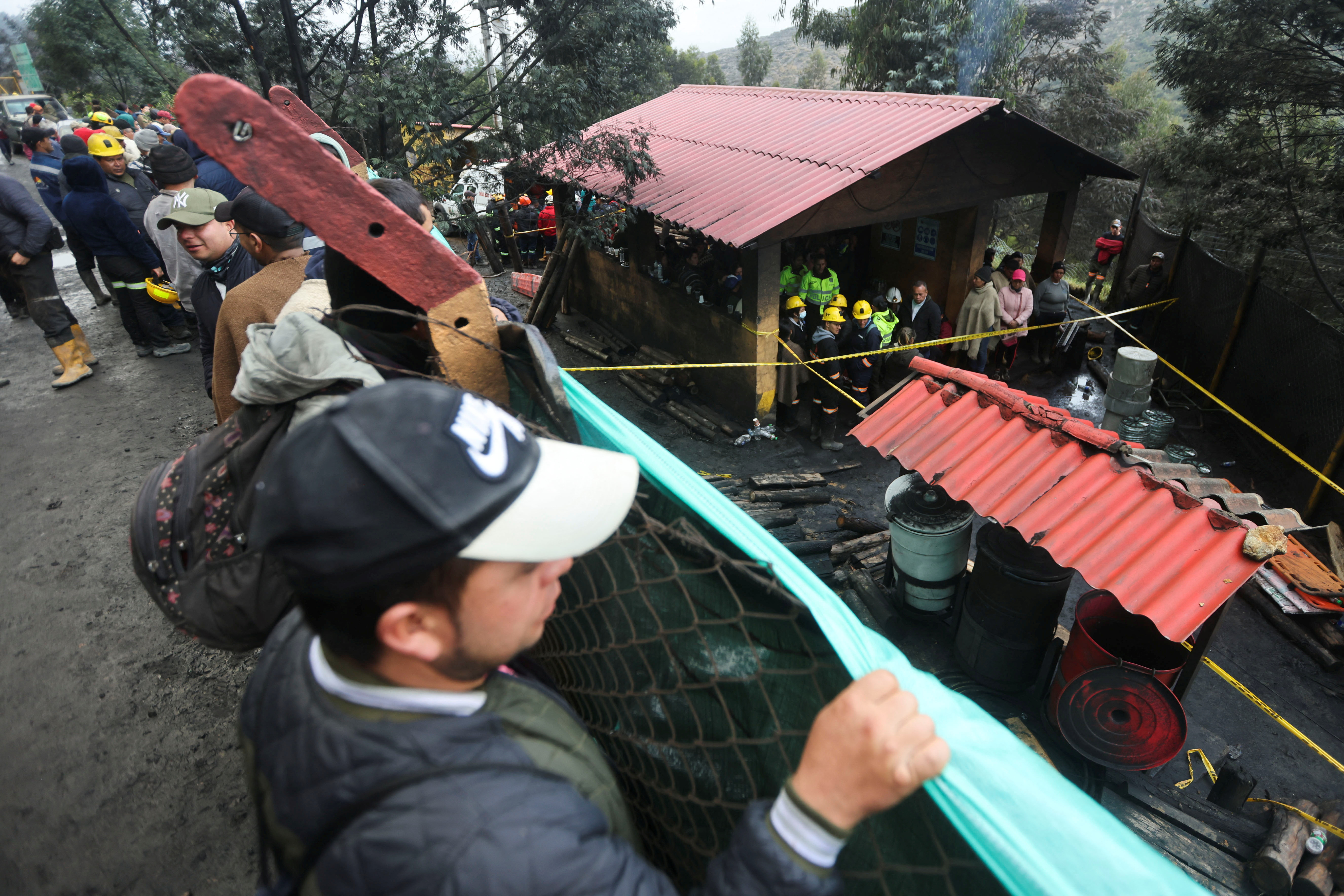 People wait during the search and rescue work following an explosion of a mine in Sutatausa, Colombia, March 15, 2023