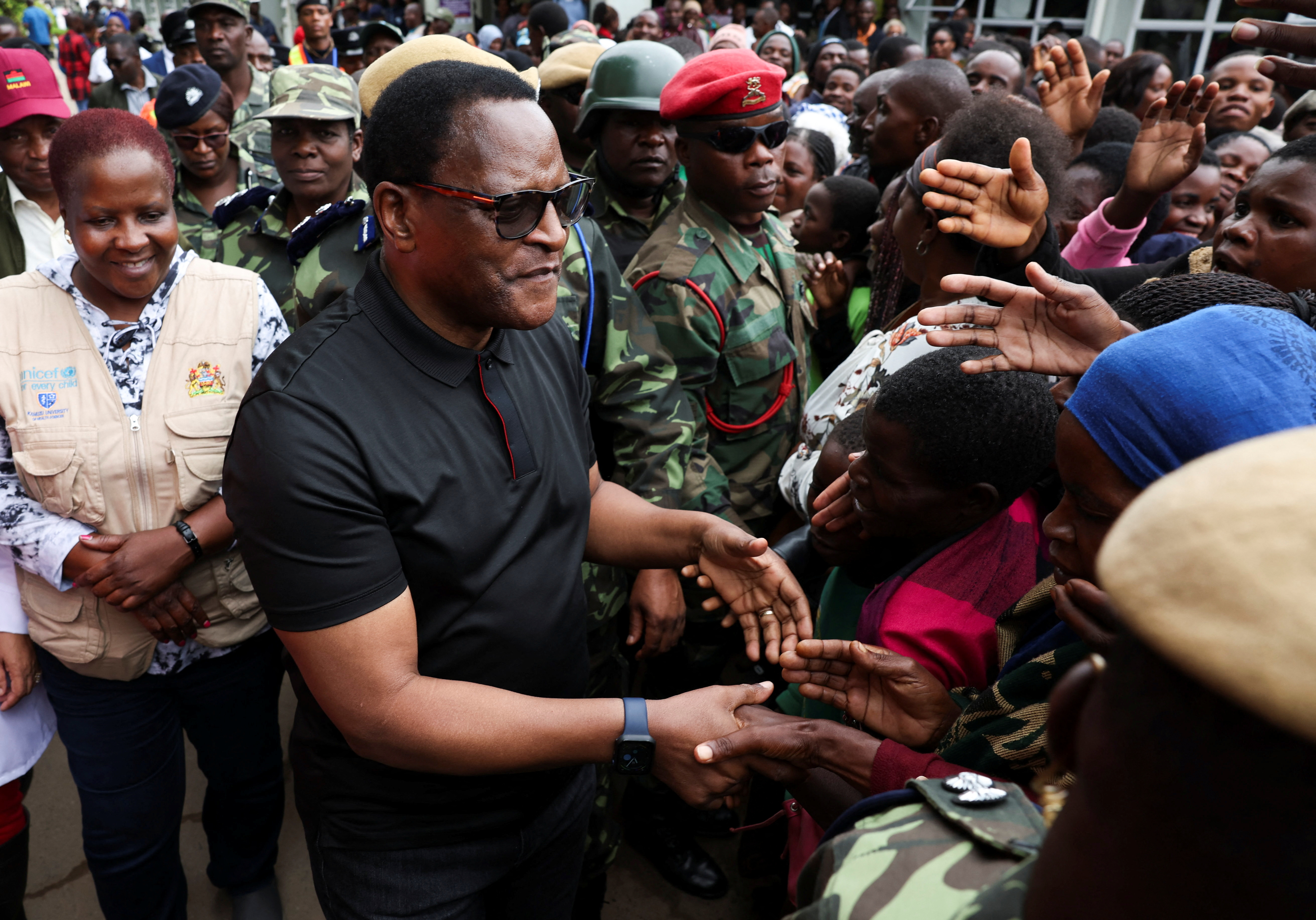 Malawi's President Lazarus Chakwera greets people after visiting flood victims at Queen Elizabeth Central hospital in Blantyre, Malawi,
