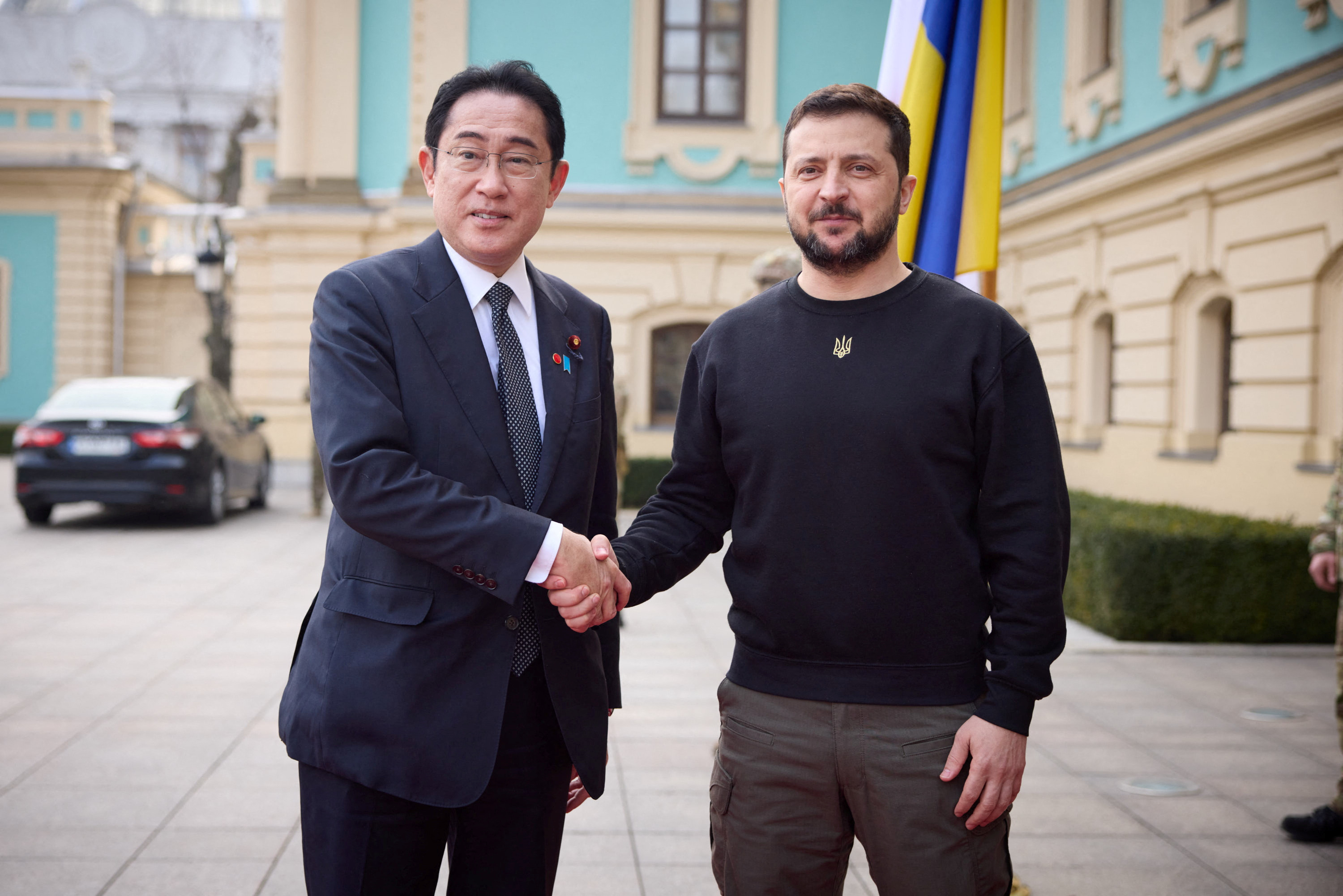 Ukraine's President Volodymyr Zelenskyy and Japan's Prime Minister Fumio Kishida shake hands as they meet in Kyiv.