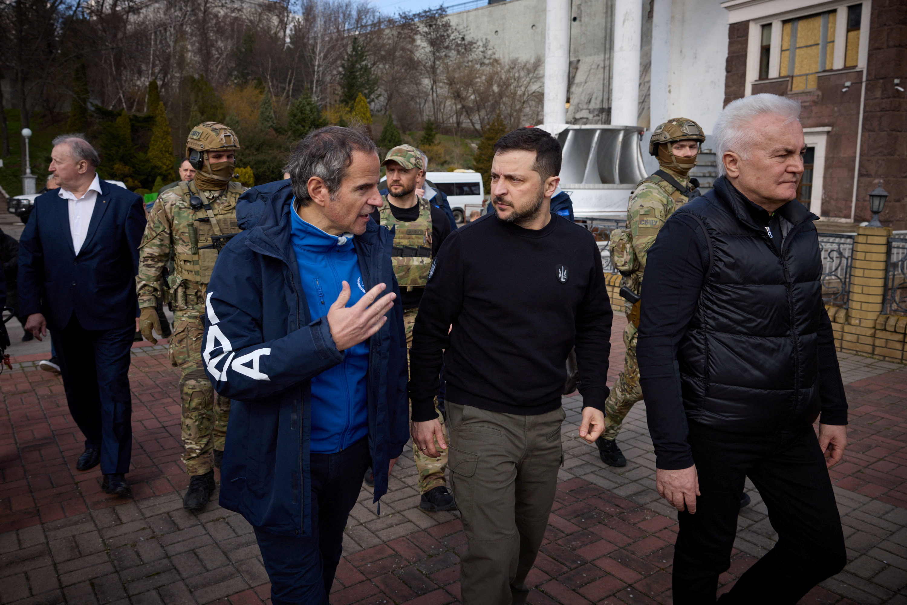 International Atomic Energy Agency Director General Rafael Grossi speaks to Ukraine's President Volodymyr Zelenskiy as they walk to visit the Dnipro Hydroelectric Power Plant, amid Russia's attack on Ukraine, in Zaporizhzhia, Ukraine.