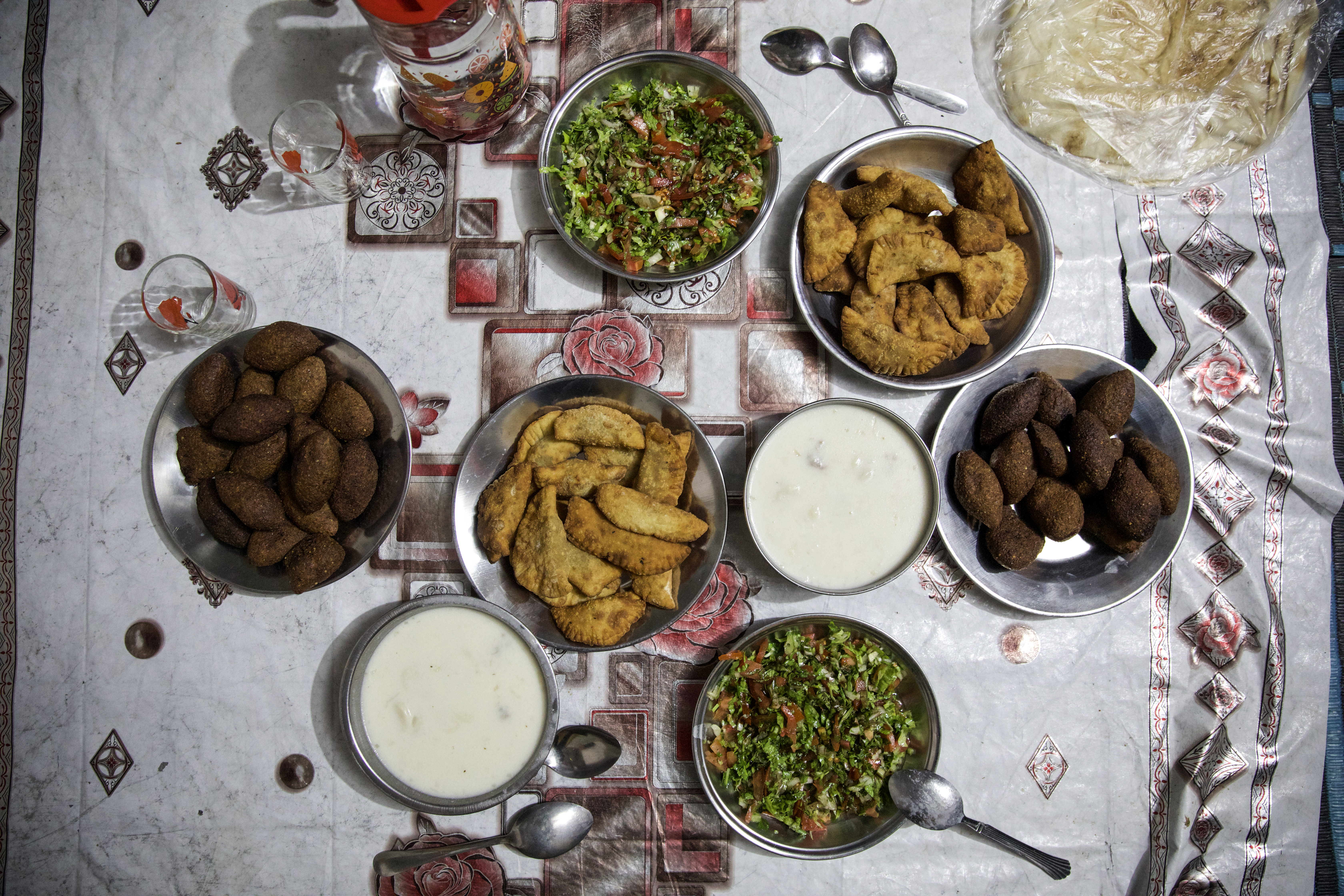 Overhead view of the food laid out on a tablecloth on the floor