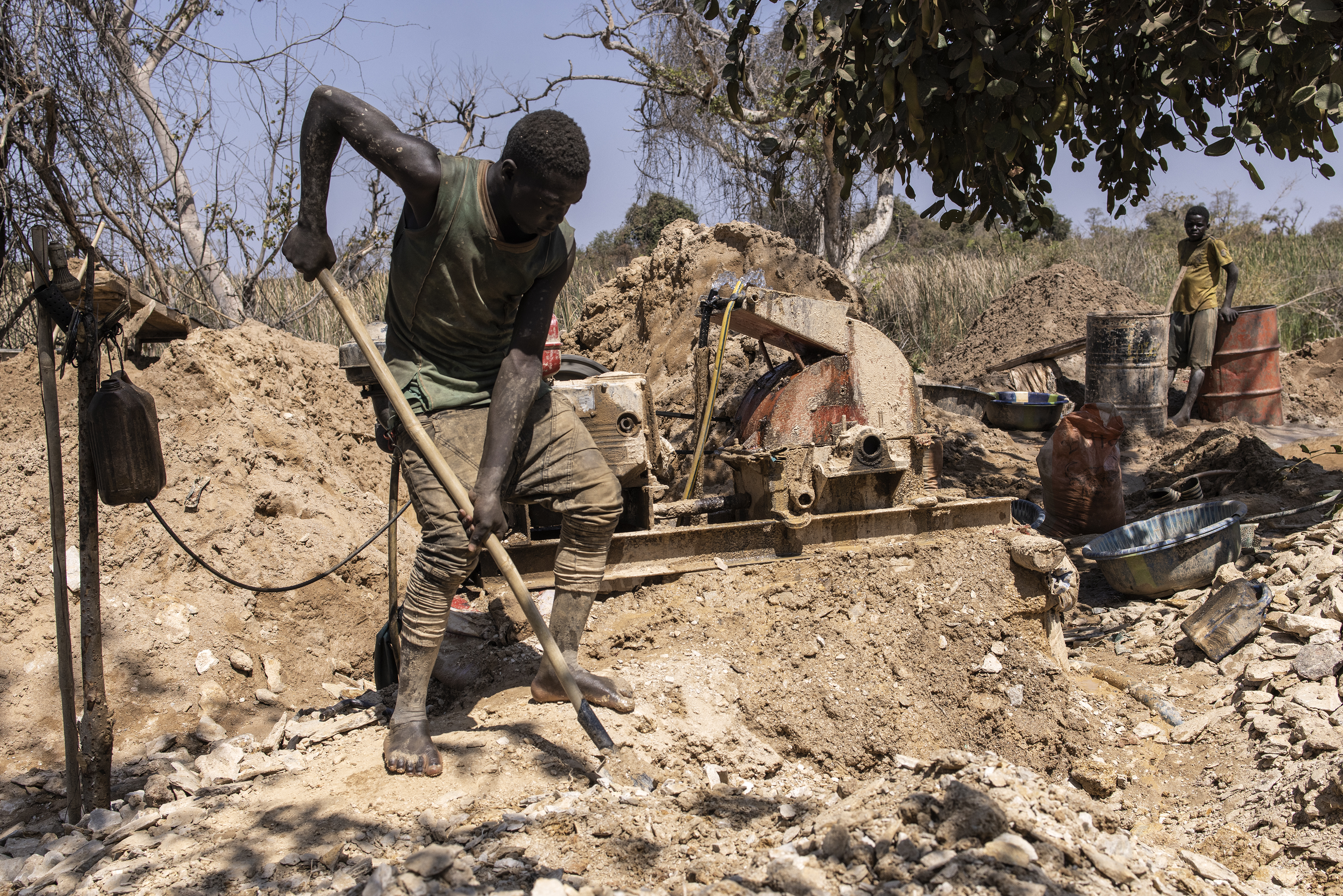 An artisanal miner pans for gold at the Karakaene gold mine