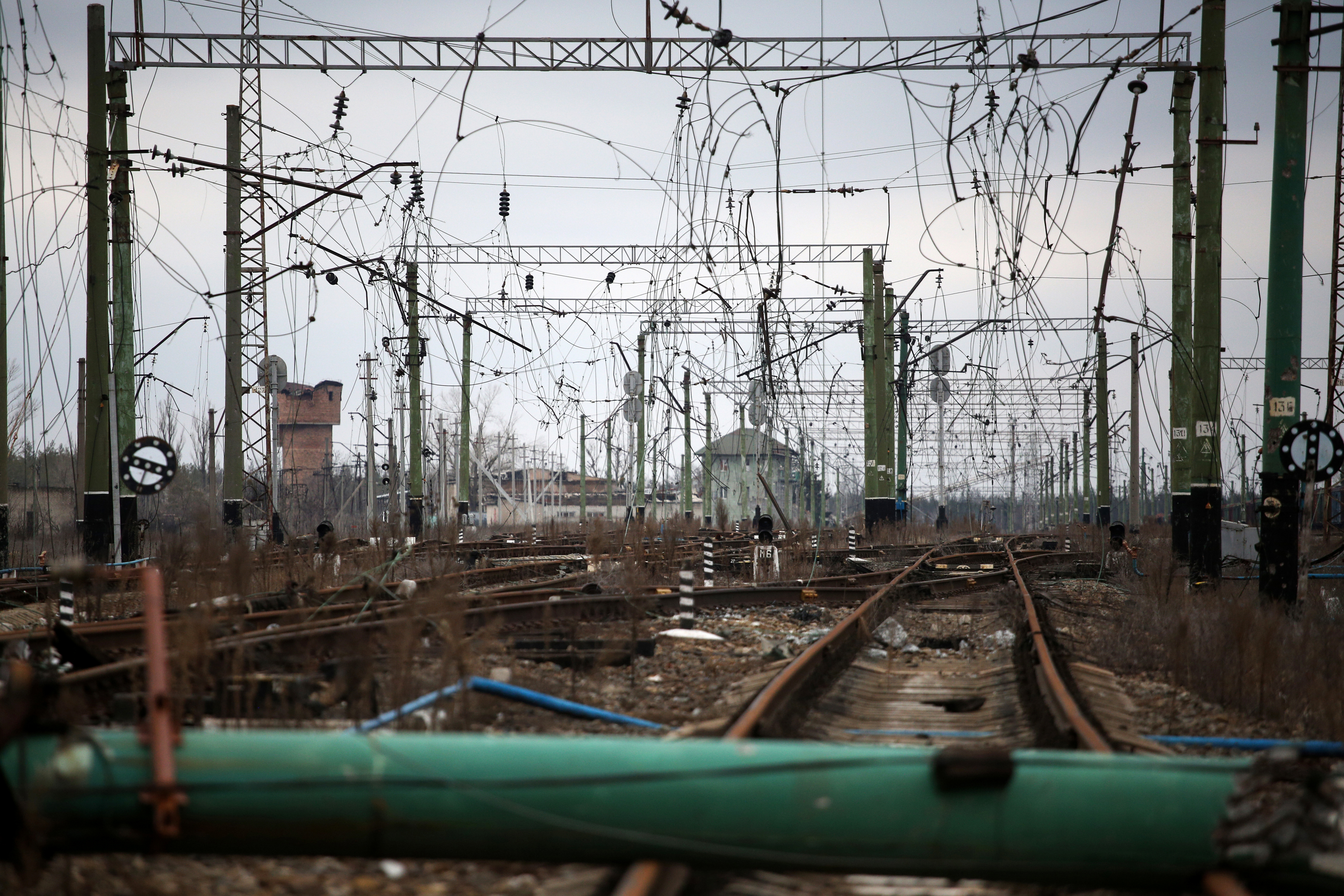 This photograph shows war damaged railroad tracks and power lines in the Sosnove village, Donetsk region