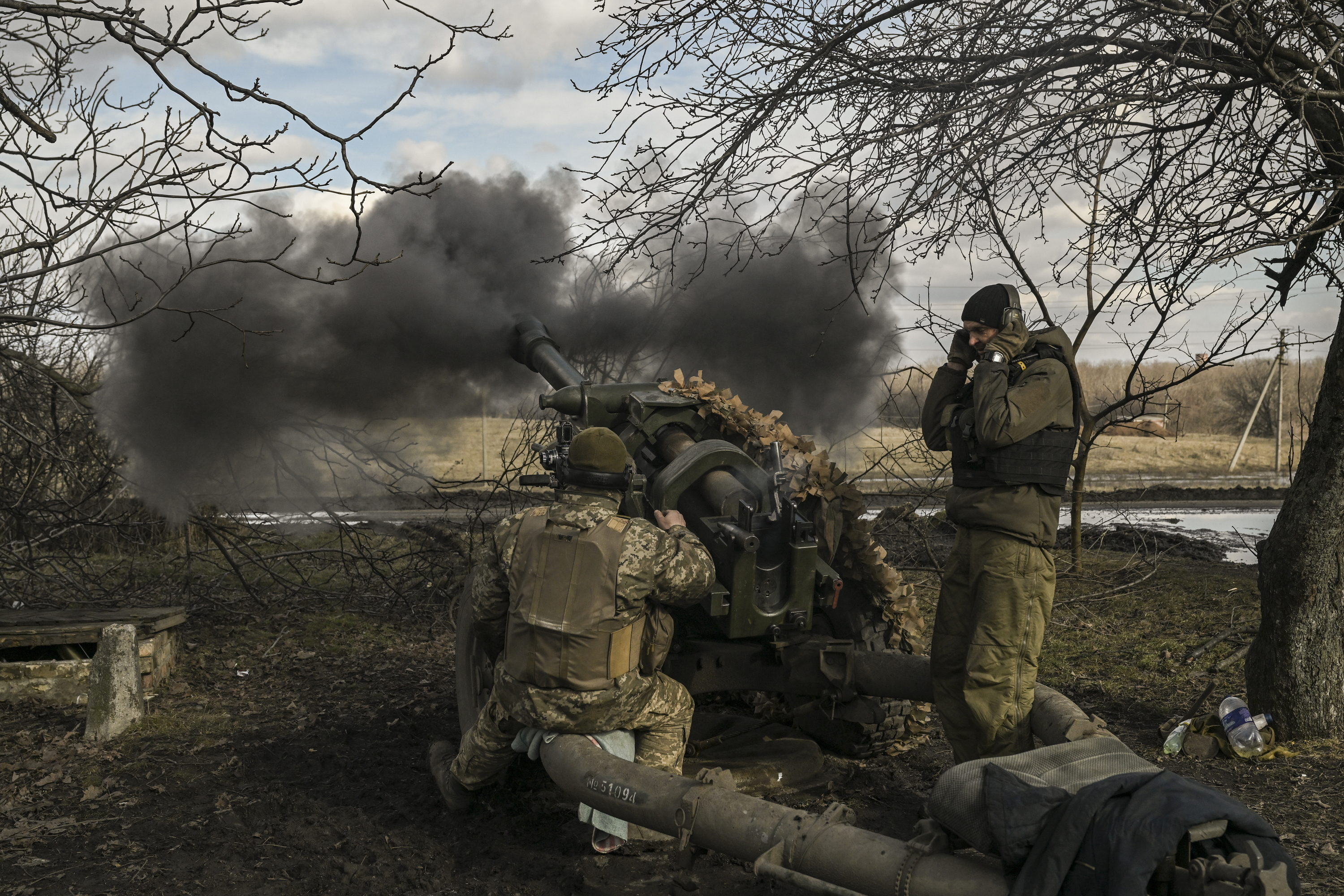 Ukrainian servicemen fire a 105mm Howitzer towards Russian positions, near the city of Bakhmut