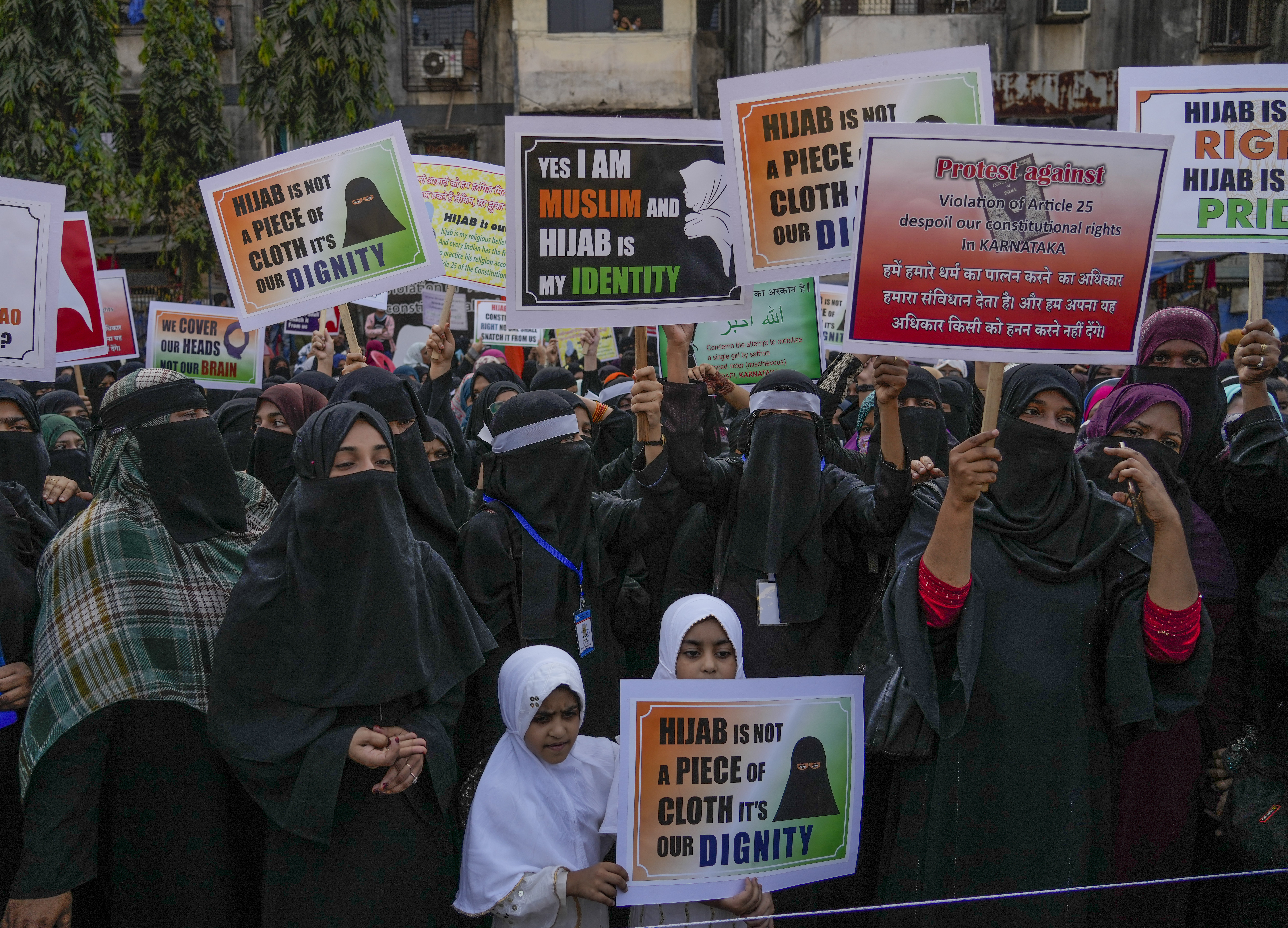 Indian Muslim women shout slogans against banning Muslim girls wearing hijab from attending classes at some schools in the southern Indian state of Karnataka during a protest in Mumbai, India, Sunday, Feb. 13, 2022. (AP Photo/Rafiq Maqbool)
