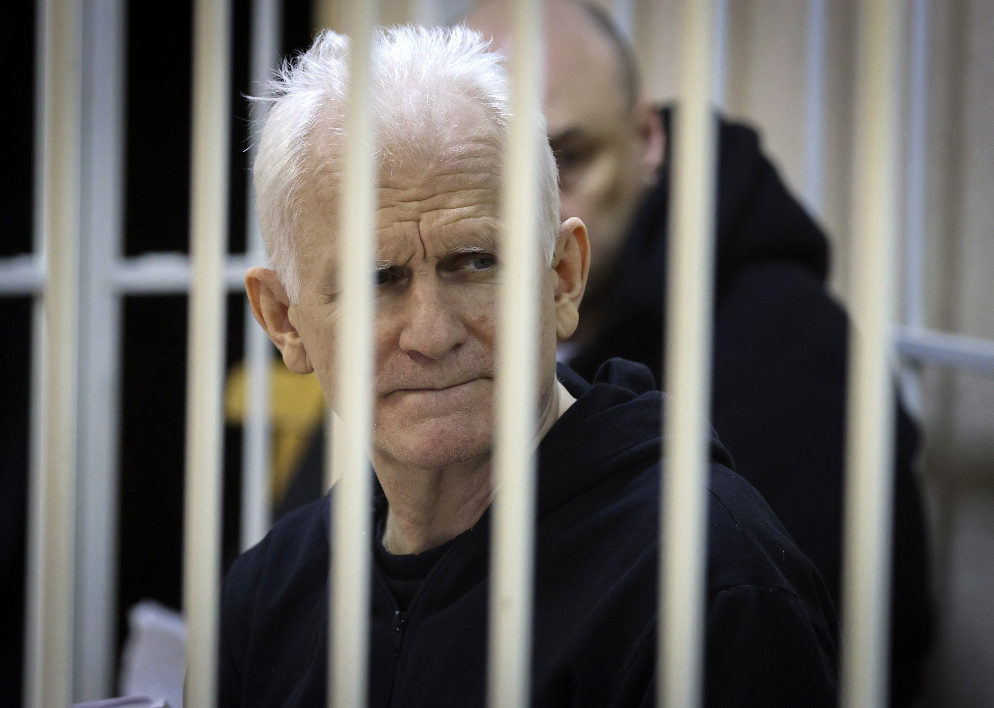 Ales Bialiatski, the head of Belarusian Vyasna rights group, sits in a defendants' cage during a court session in Minsk,