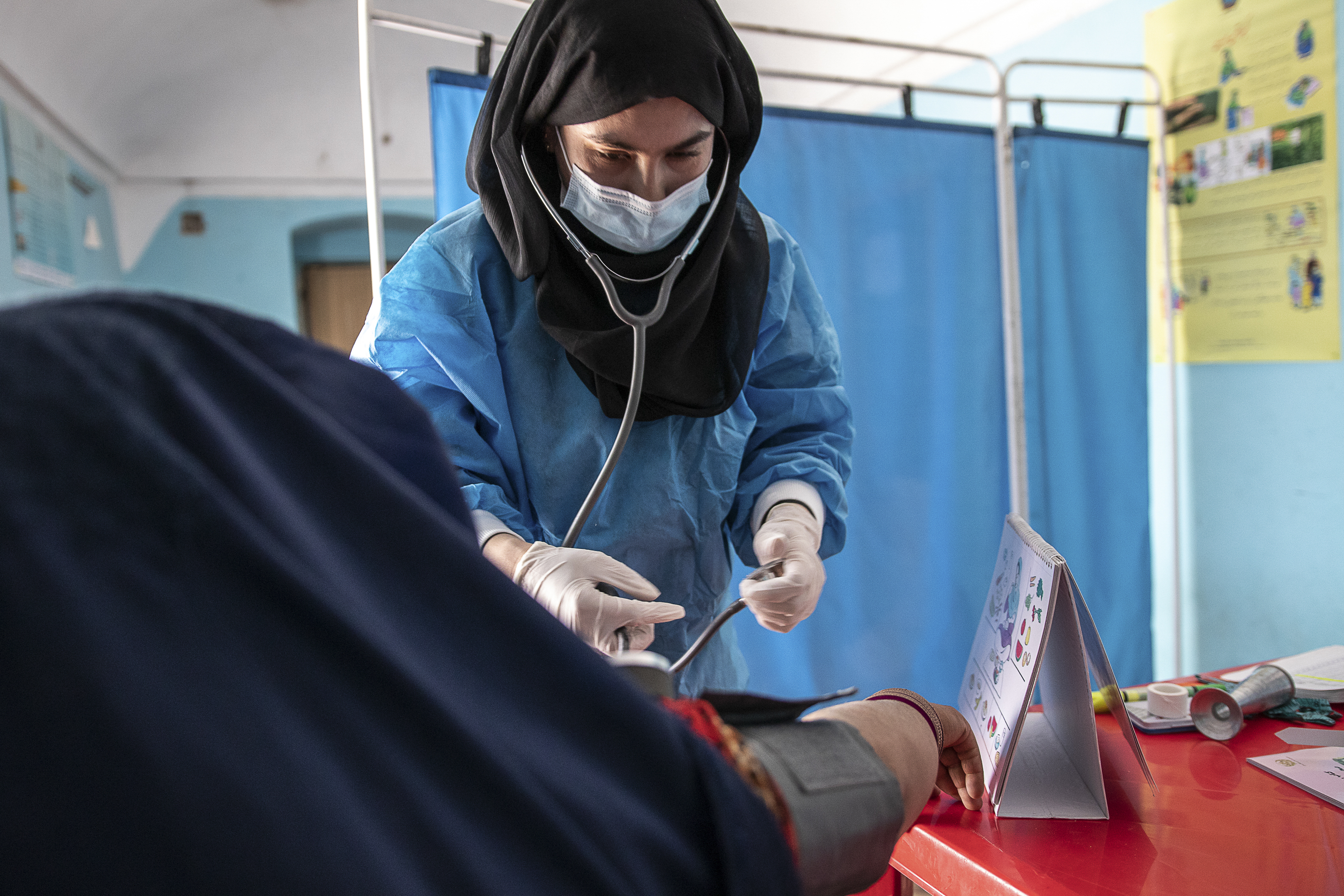 A Save the Children midwife provides Zarmina, 25, who is five-months pregnant, with a pre-natal check-up in Jawzjan province in northern Afghanistan on October 2, 2022 [Save the Children via AP]