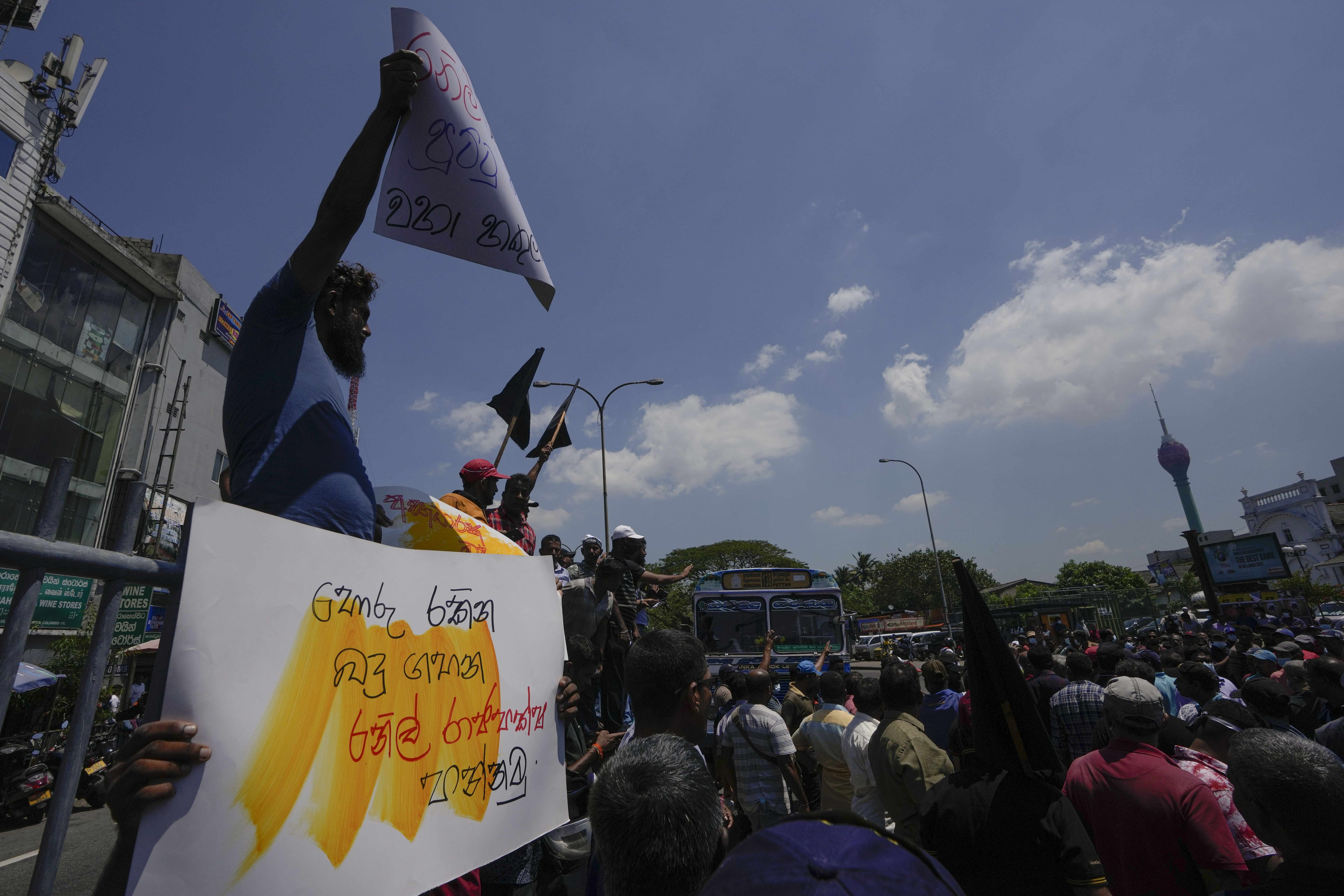 Sri Lankans shout slogans during a protest against the government increasing income tax to manage day to day expenses amid an unprecedented economic crisis in Colombo, Sri Lanka, Wednesday, Feb. 22, 2023. The government says it has been forced to increase taxes because of a severe cash crunch and the success of its talks with the International Monetary Fund depends on a strong public revenue structure. (AP Photo/Eranga Jayawardena)