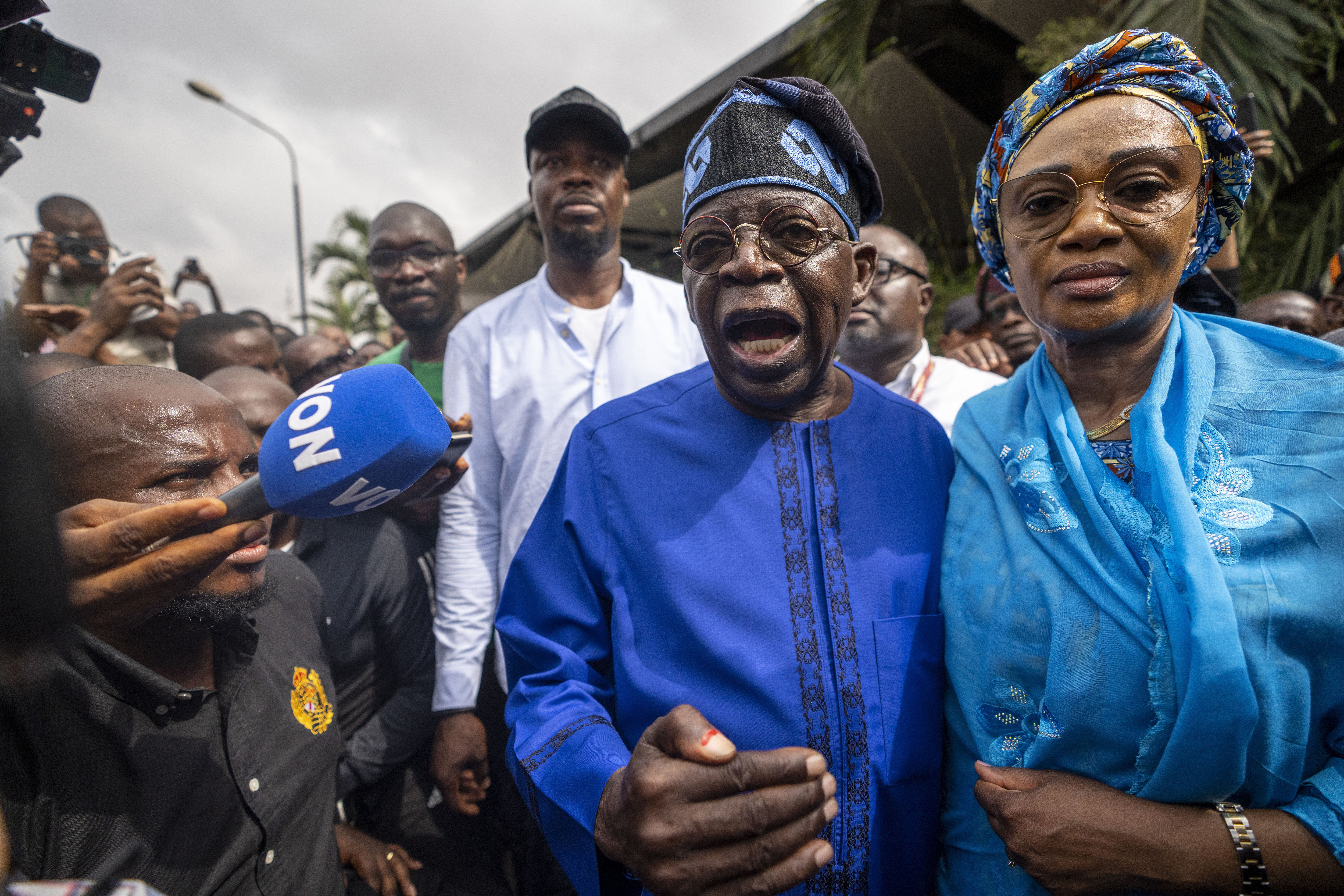Nigerian President-elect Bola Tinubu. He is with his wife and talking to the media just after voting.