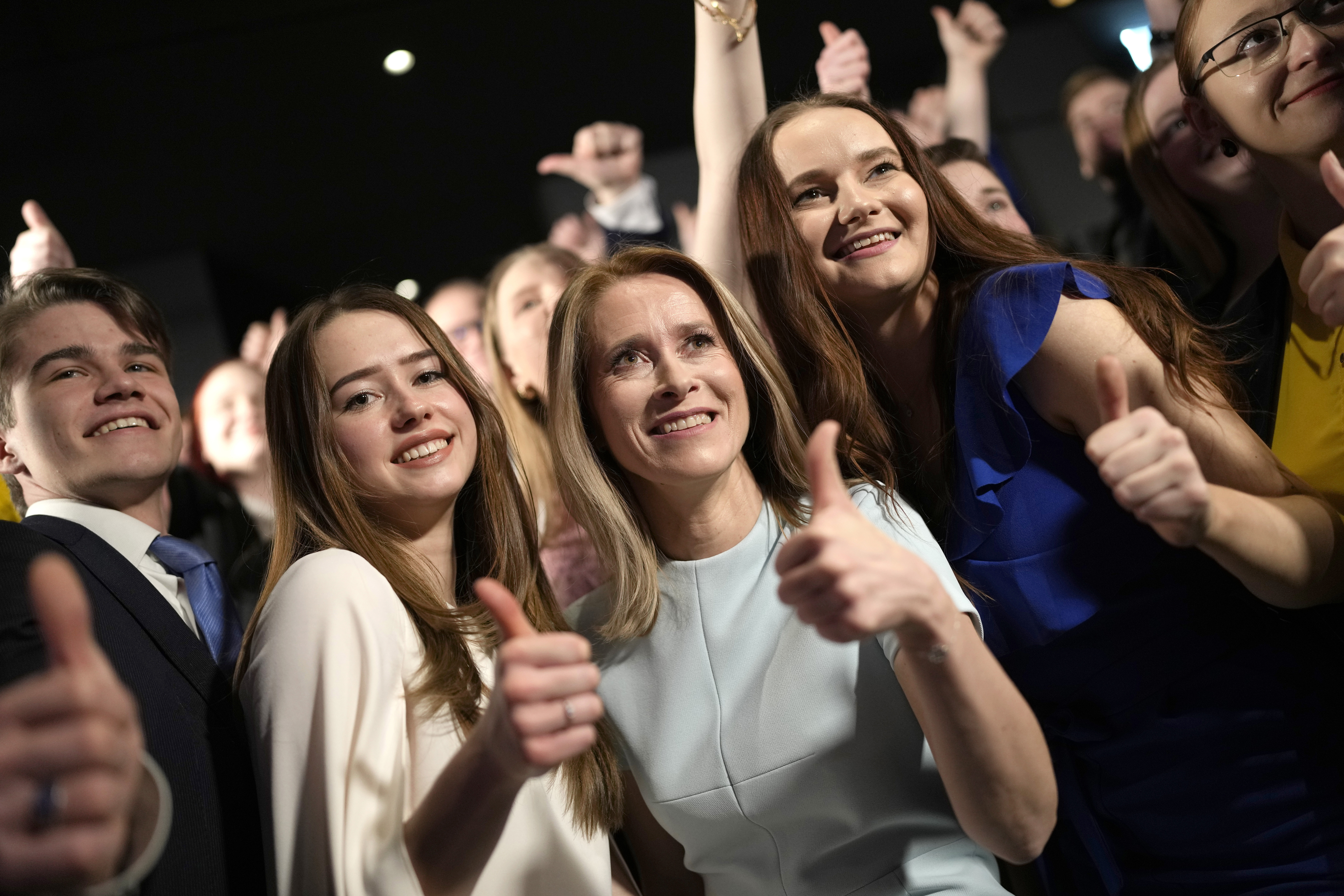 Estonian Prime Minister Kaja Kallas with supporters in Tallinn, Estonia. She's giving a thumbs up and so is one of the women with her.