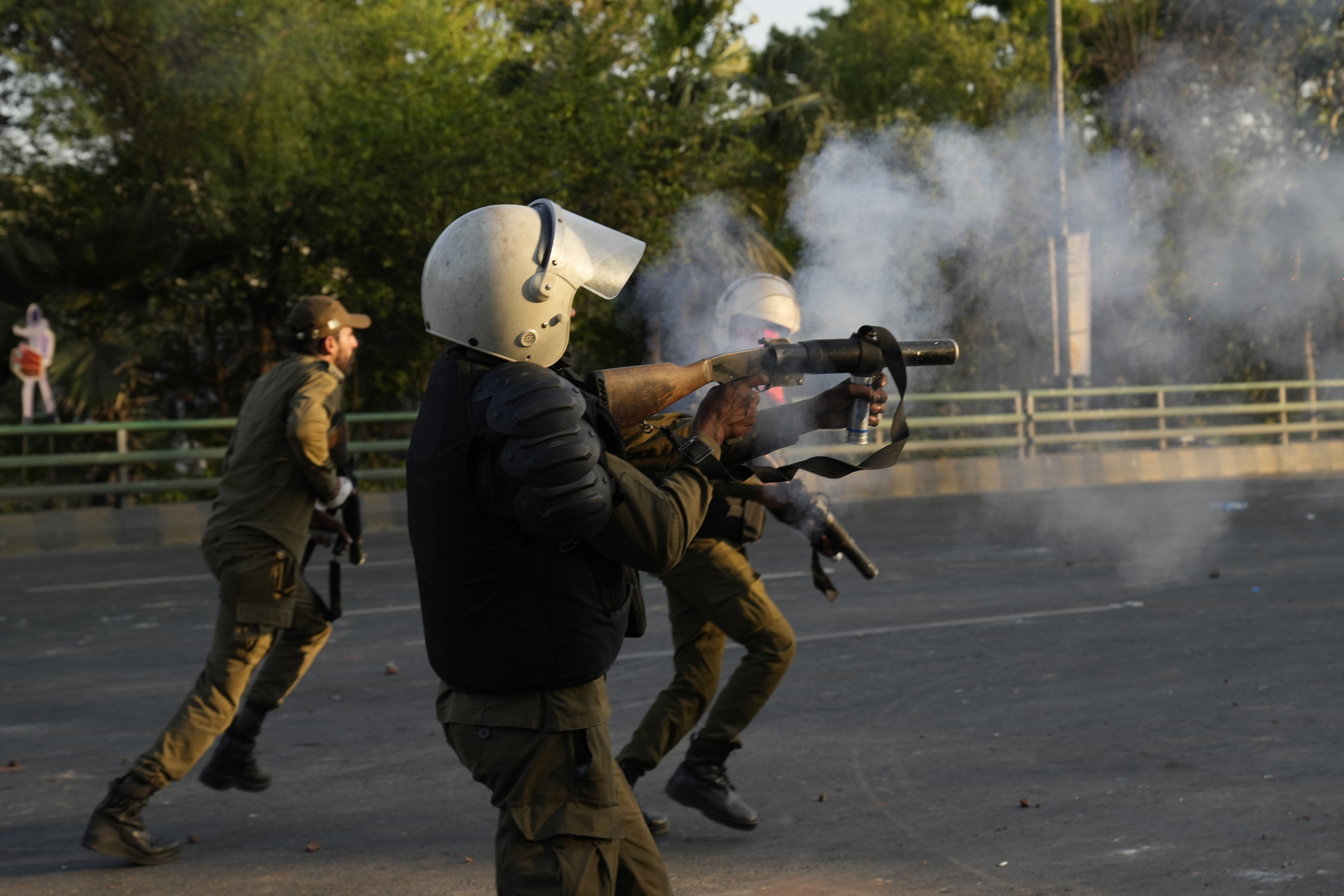 Police officers fire tear gas shells to disperse the supporters of Pakistan's former Prime Minister Imran Khan in Lahore.