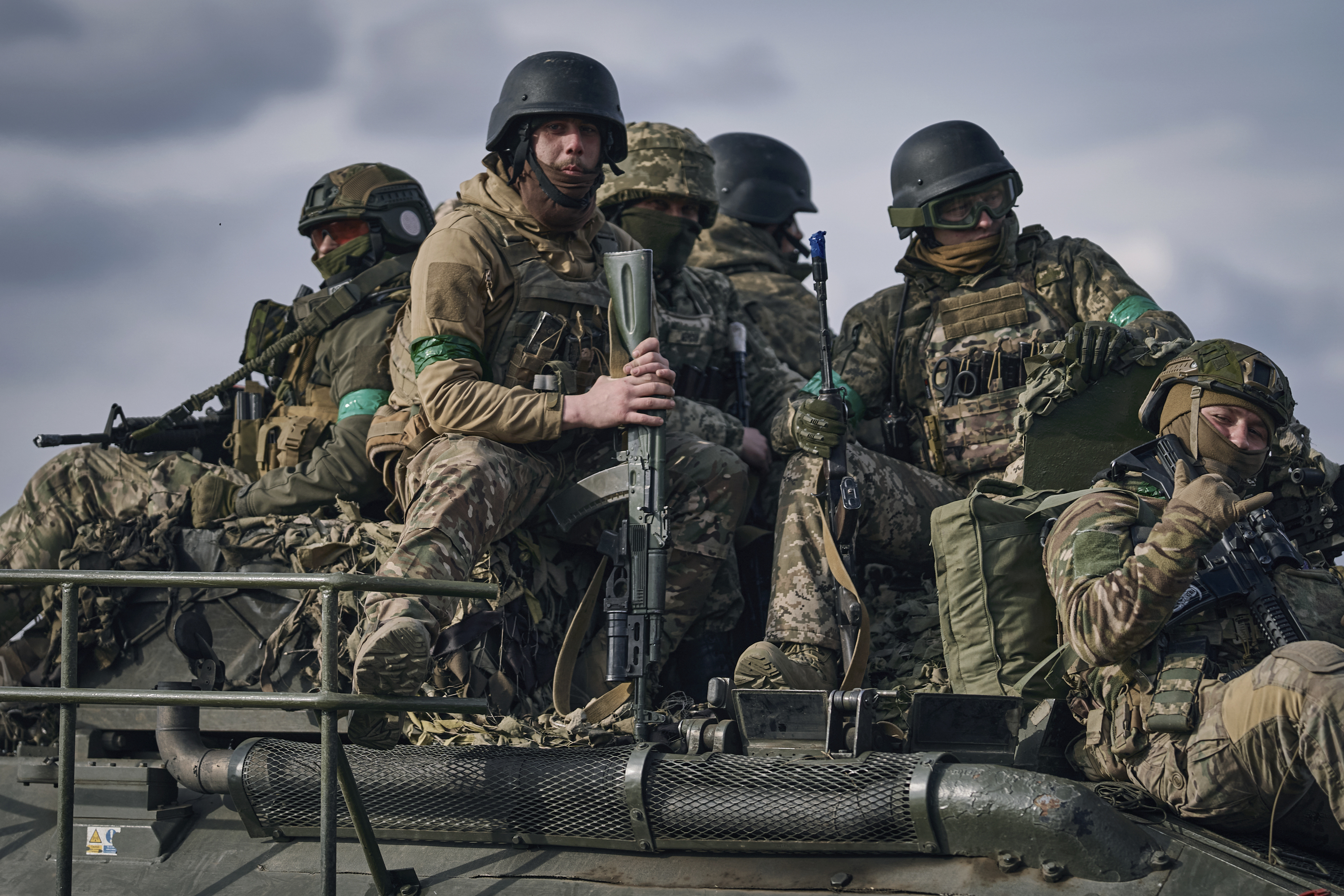 Ukrainian soldiers ride atop an APC on the frontline in Bakhmut, Donetsk region, Ukraine, Sunday, March 26, 2023.