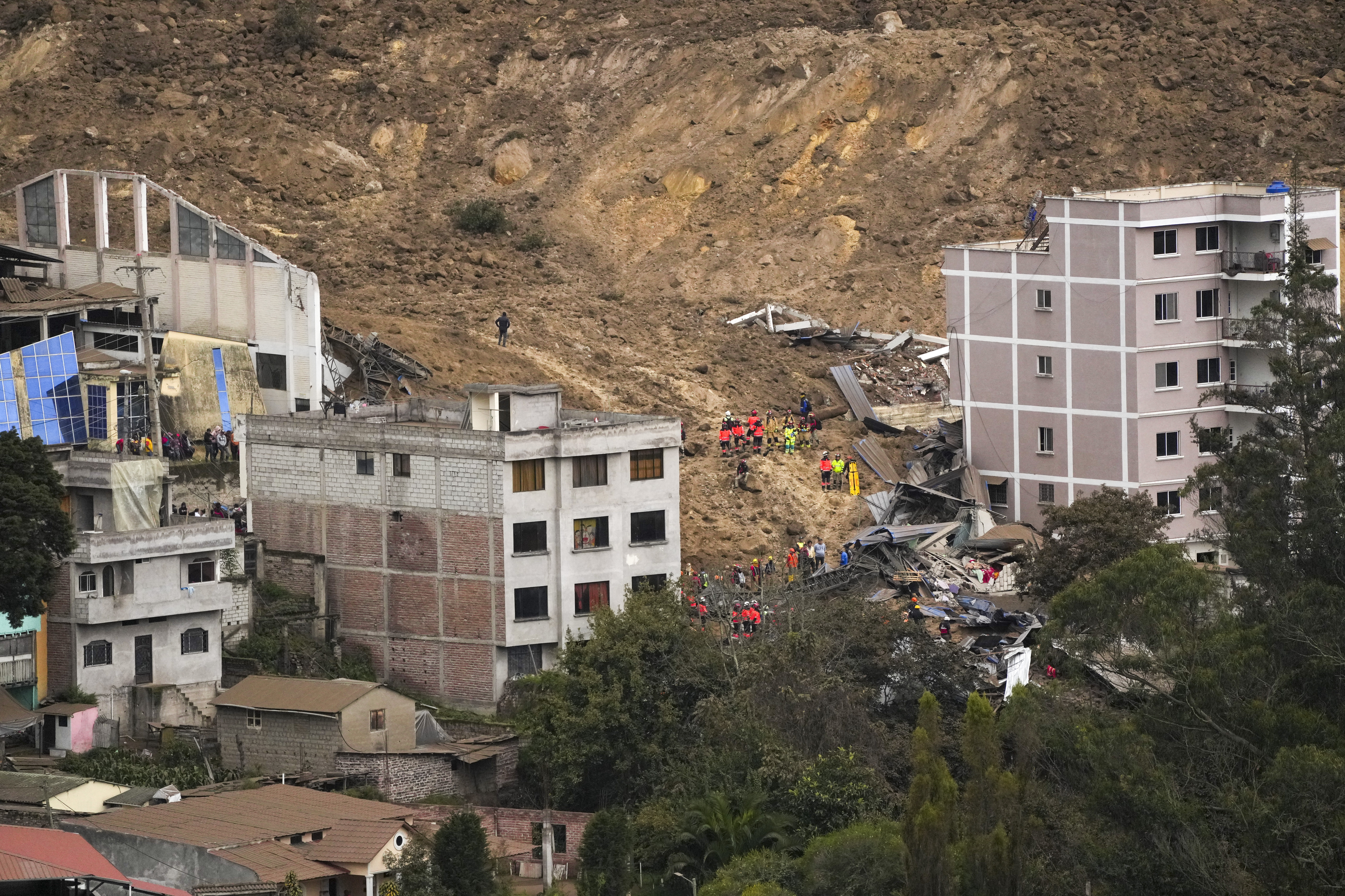 Rescue work is carried out at the site of a landslide that buried dozens of homes in Alausi, Ecuador