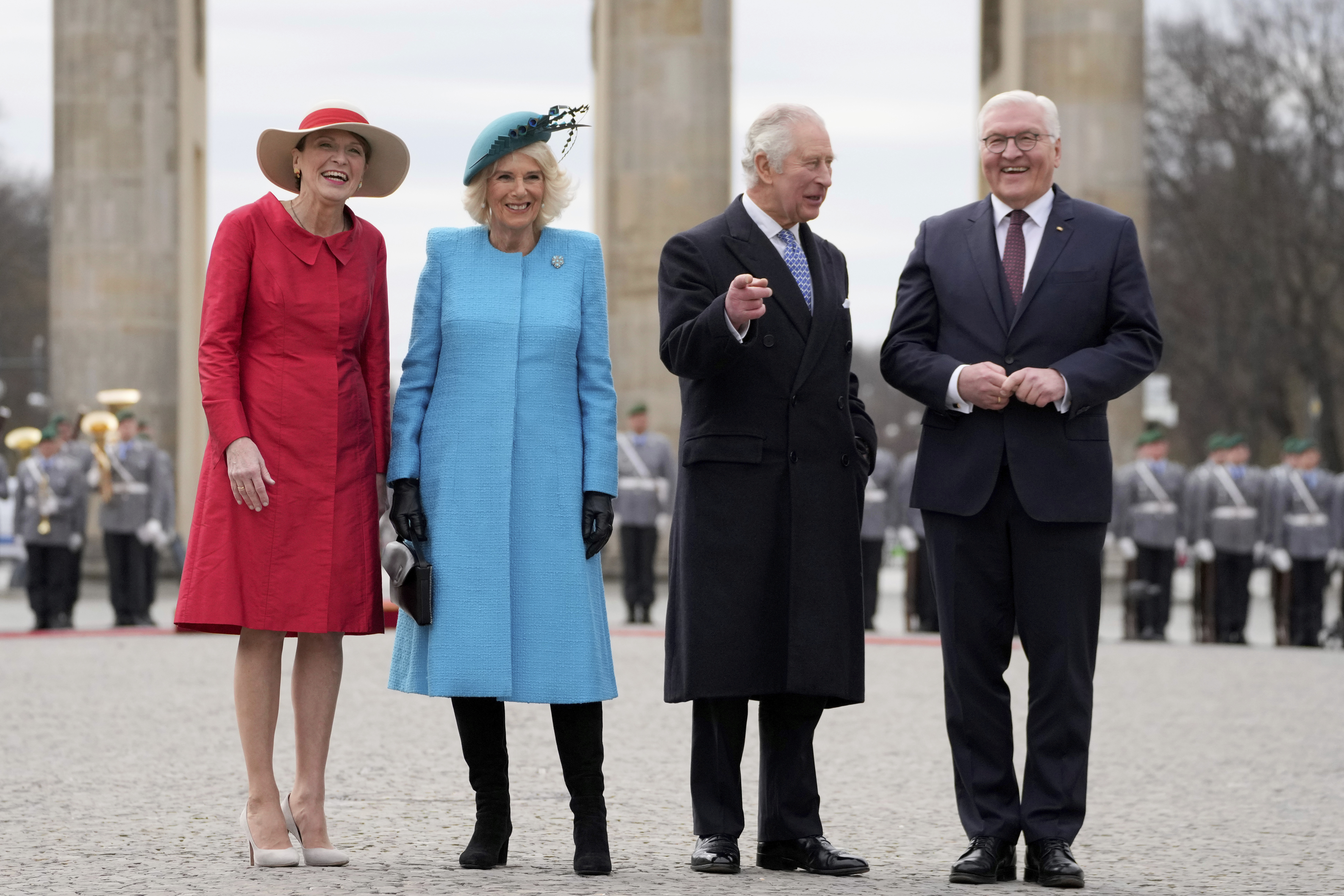 German President Frank-Walter Steinmeier, right, and his wife Elke Buedenbender, left, welcome Britain's King Charles III and Camilla, the Queen Consort, in front of the Brandenburg Gate in Berlin