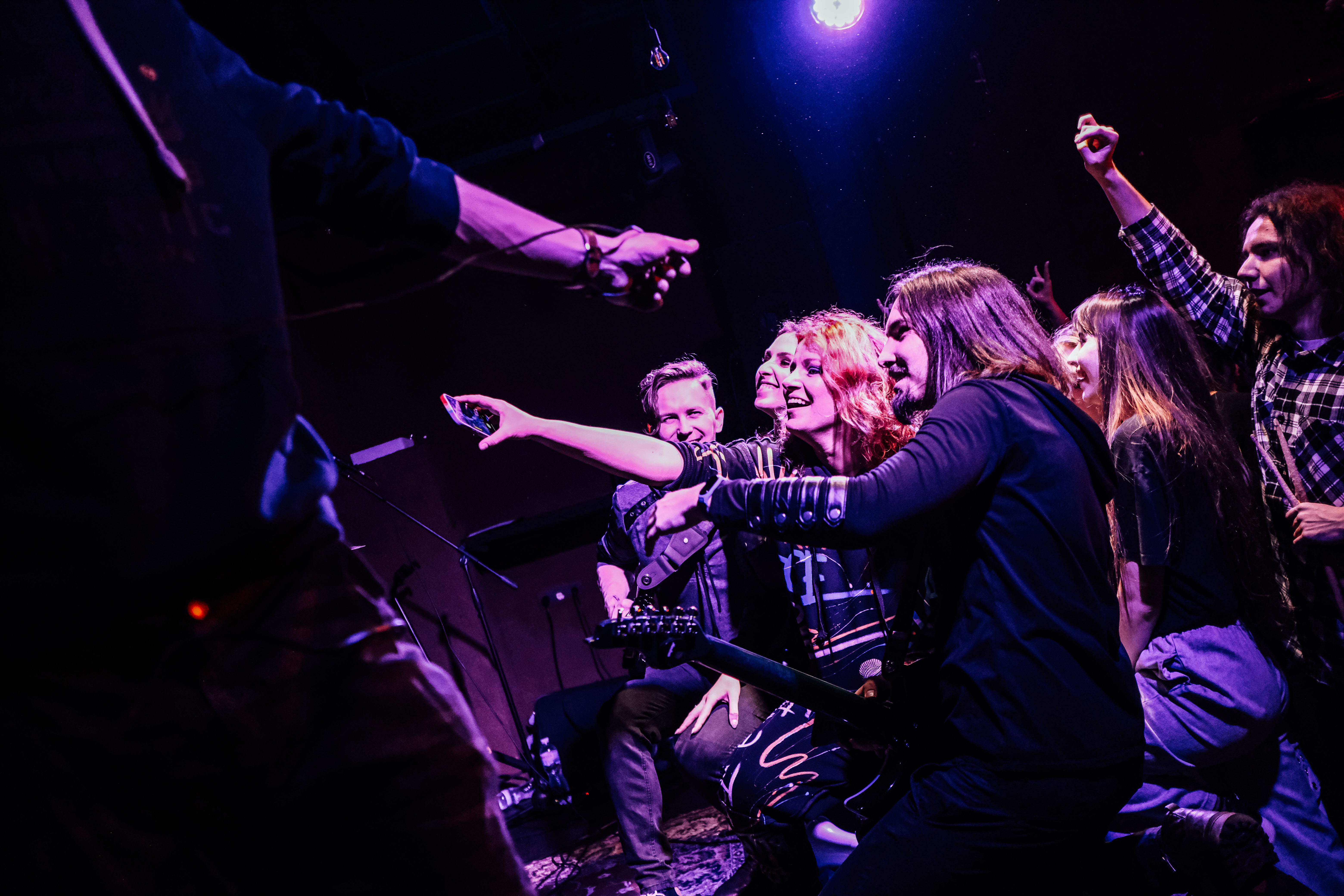 A photo of Bohdana Nykyforchyn with a group of people and her bandmates around her.