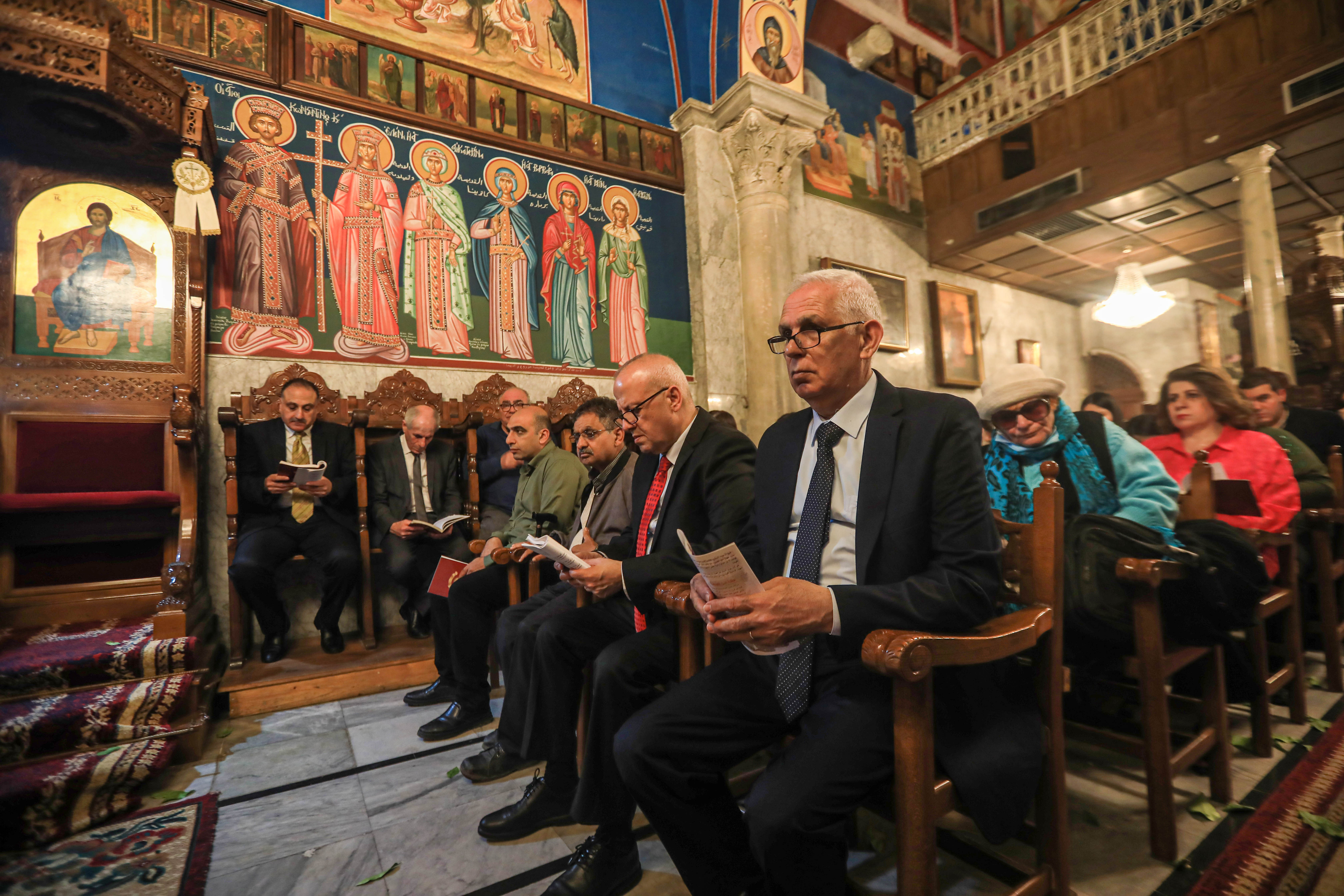 Worshippers at the Holy Sabbath service at the Church of Saint Porphyrius in Gaza on April 16, 2023