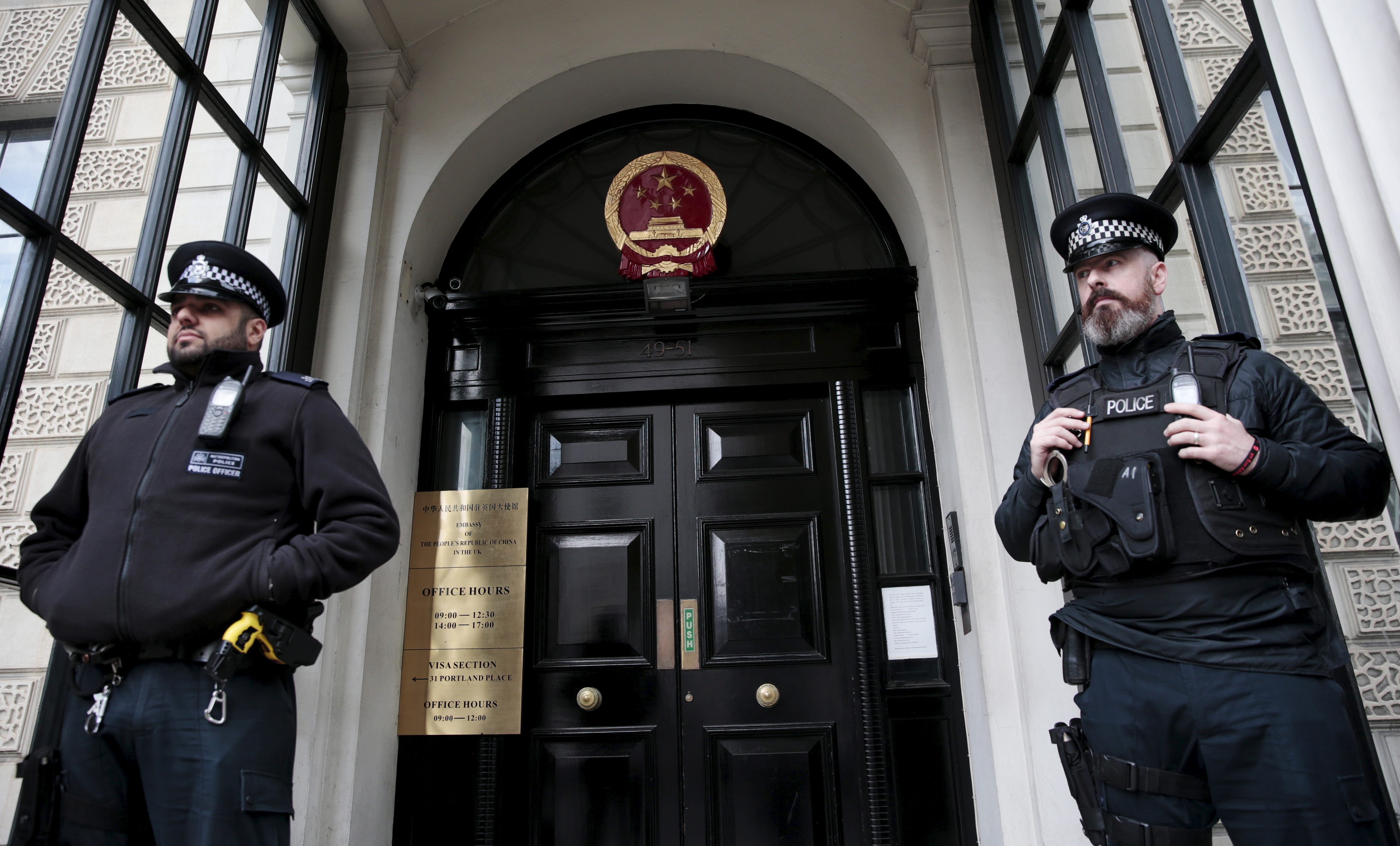 Policemen stand guard outside the Chinese Embassy in London, Britain October 18, 2015. Chinese President Xi Jinping arrives in Britain on Monday for a state visit at the invitation of Queen Elizabeth II, the first state visit to the United Kingdom by a Chinese leader since 2005. REUTERS/Suzanne Plunkett