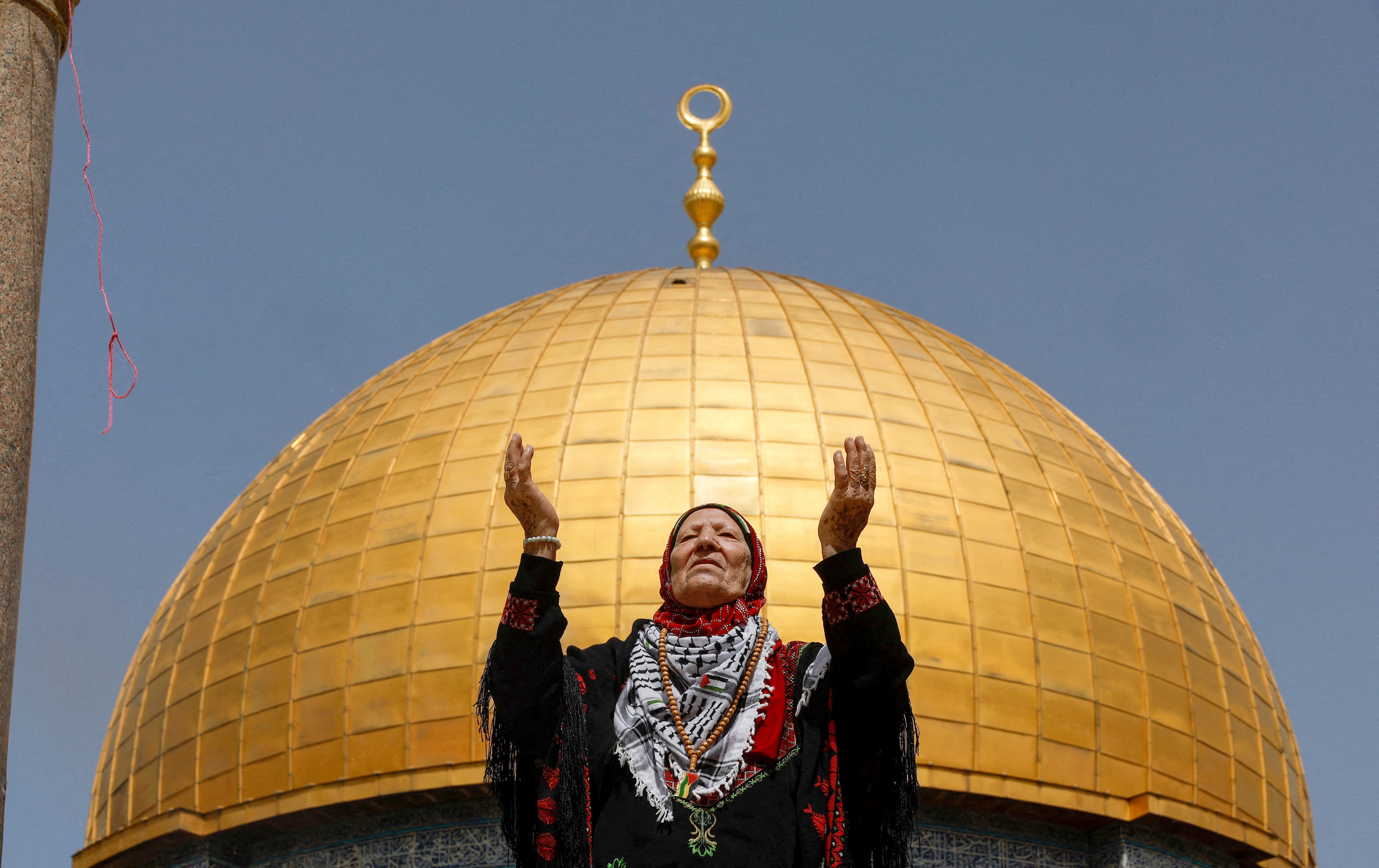 A woman prays as Palestinian Muslims attend Friday prayers of the Muslim holy month of Ramadan, on the Al-Aqsa mosque compound in Jerusalem's Old City.
