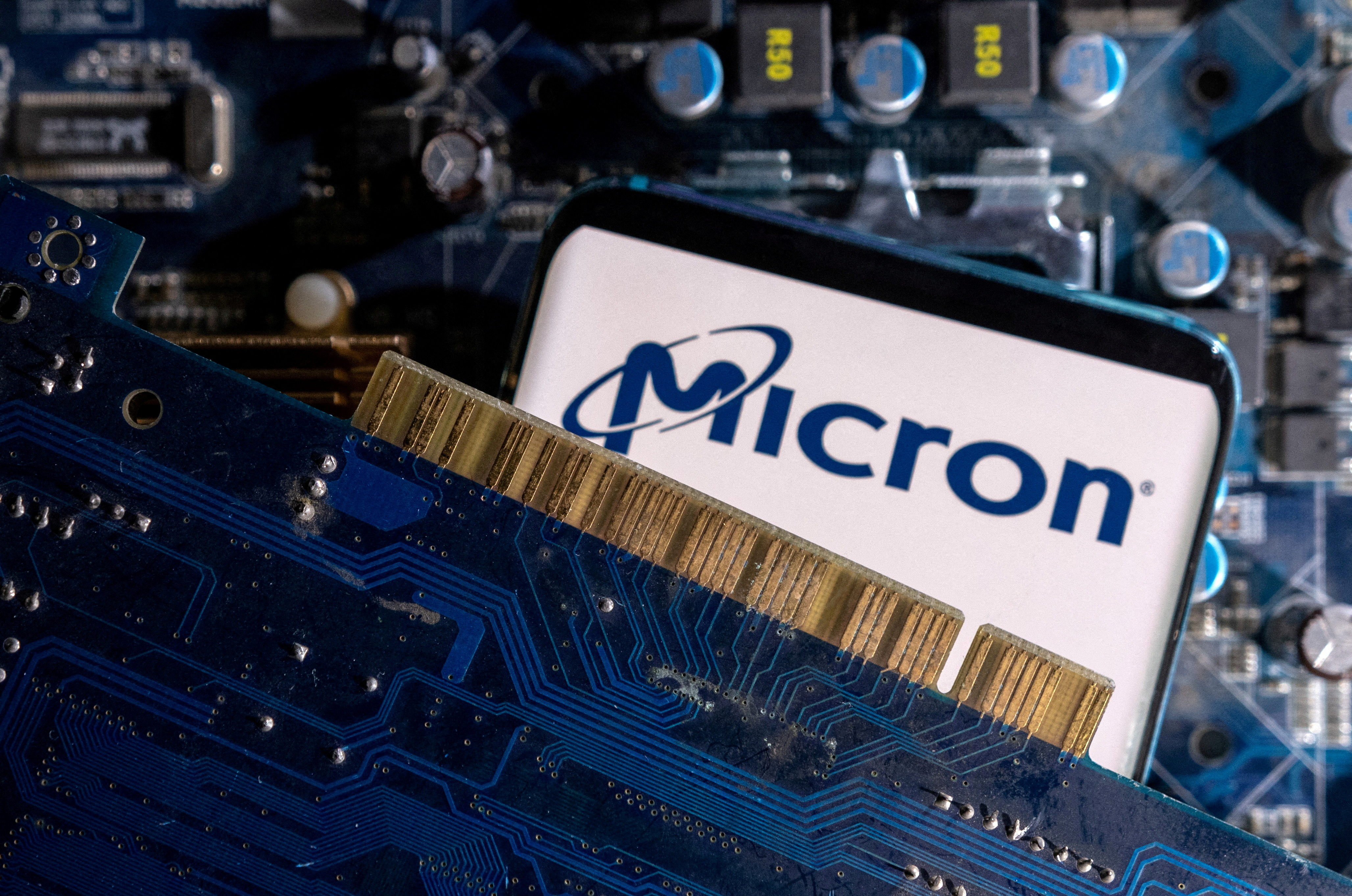 A smartphone with a displayed Micron logo is placed on a computer motherboard in this illustration taken March 6, 2023.