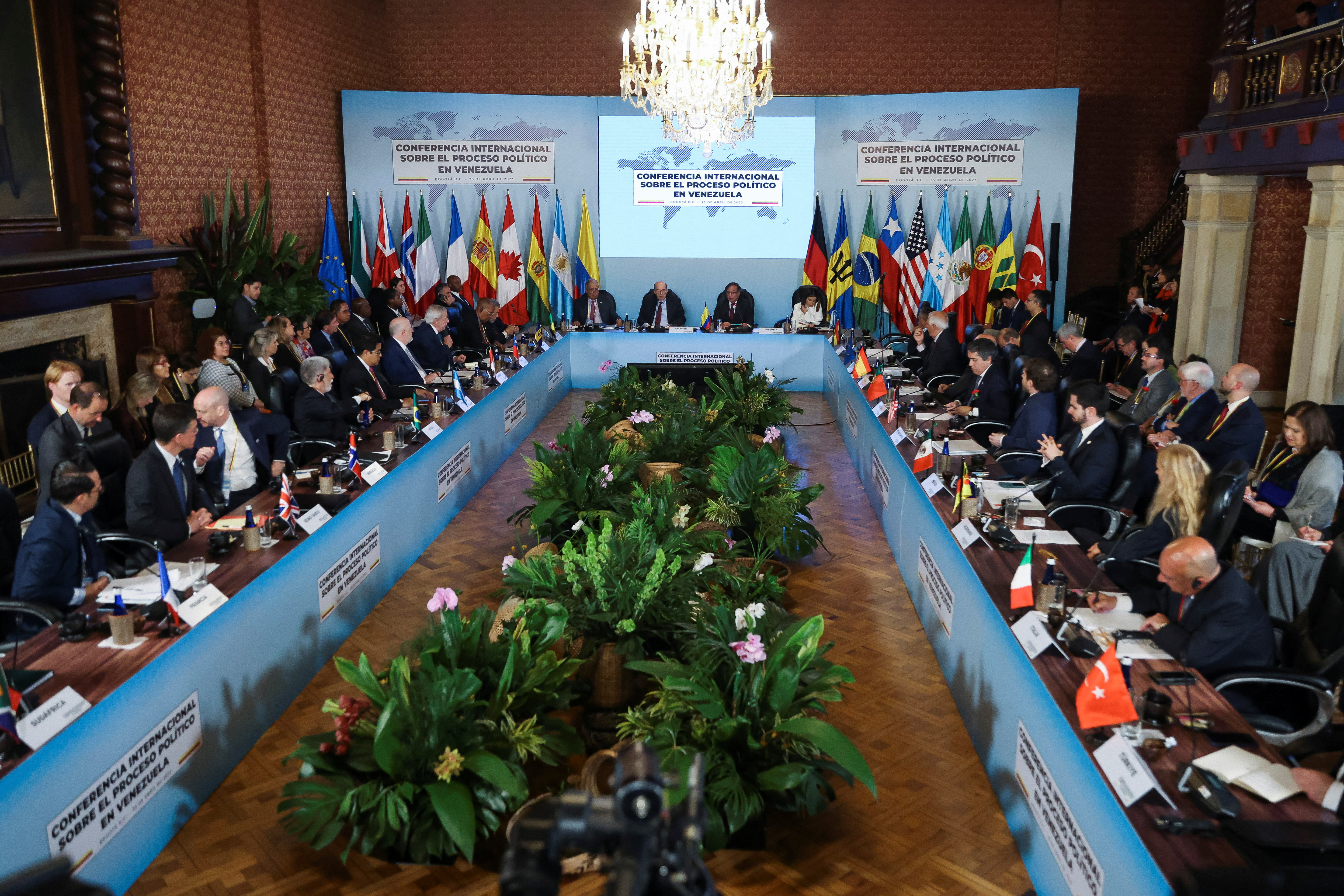 Colombian President Gustavo Petro, Colombian Foreign Minister Alvaro Leyva, and Brazil's special advisor for international affairs and former Foreign Minister Celso Amorim sit at the head of a conference table