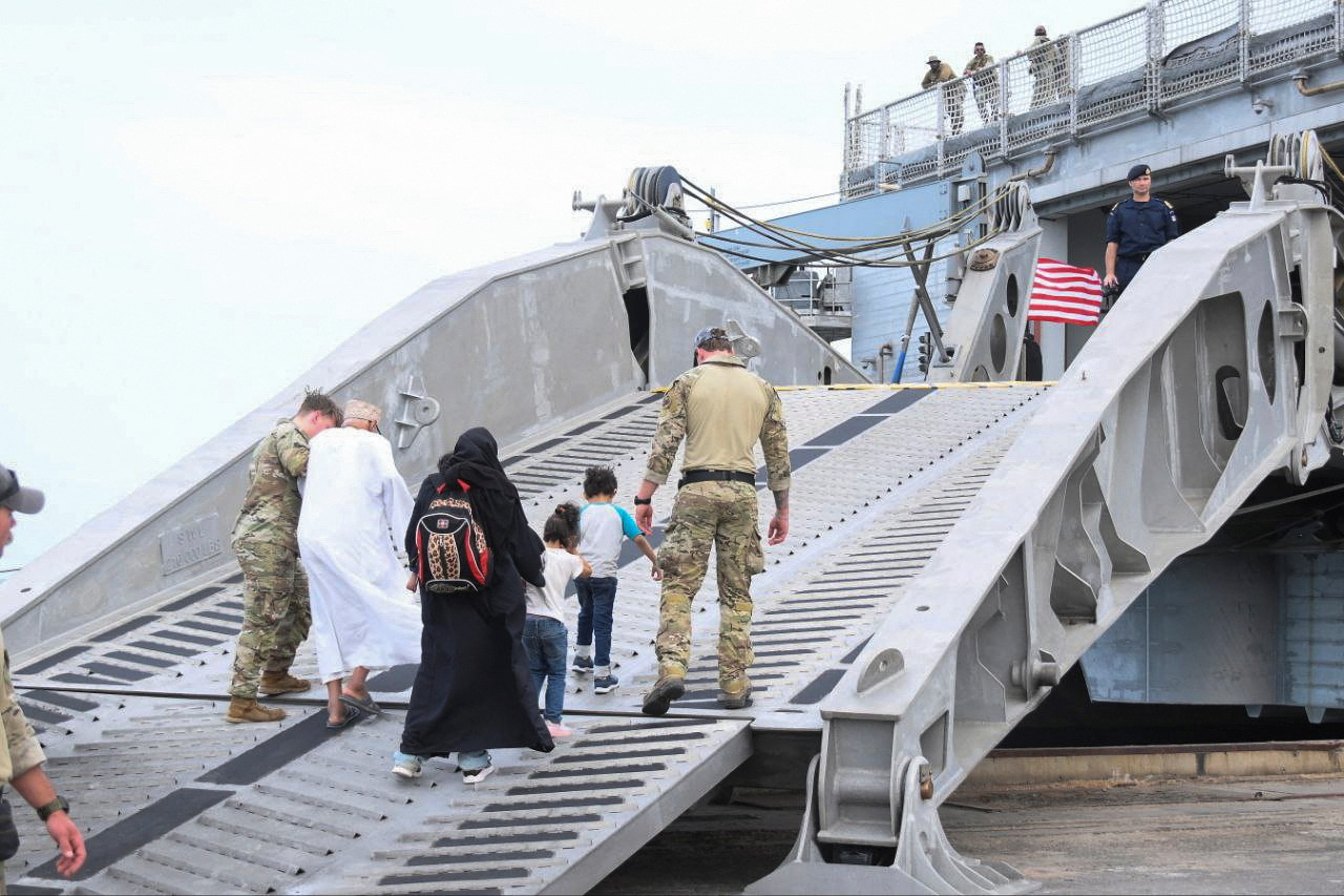 American nationals board a U.S. Navy ship, while they are evacuated from the port, as clashes between the paramilitary Rapid Support Forces and the Sudanese army continue, in Port Sudan, Sudan, April 30, 2023. REUTERS/Stringer NO RESALES. NO ARCHIVES. BEST QUALITY AVAILABLE.