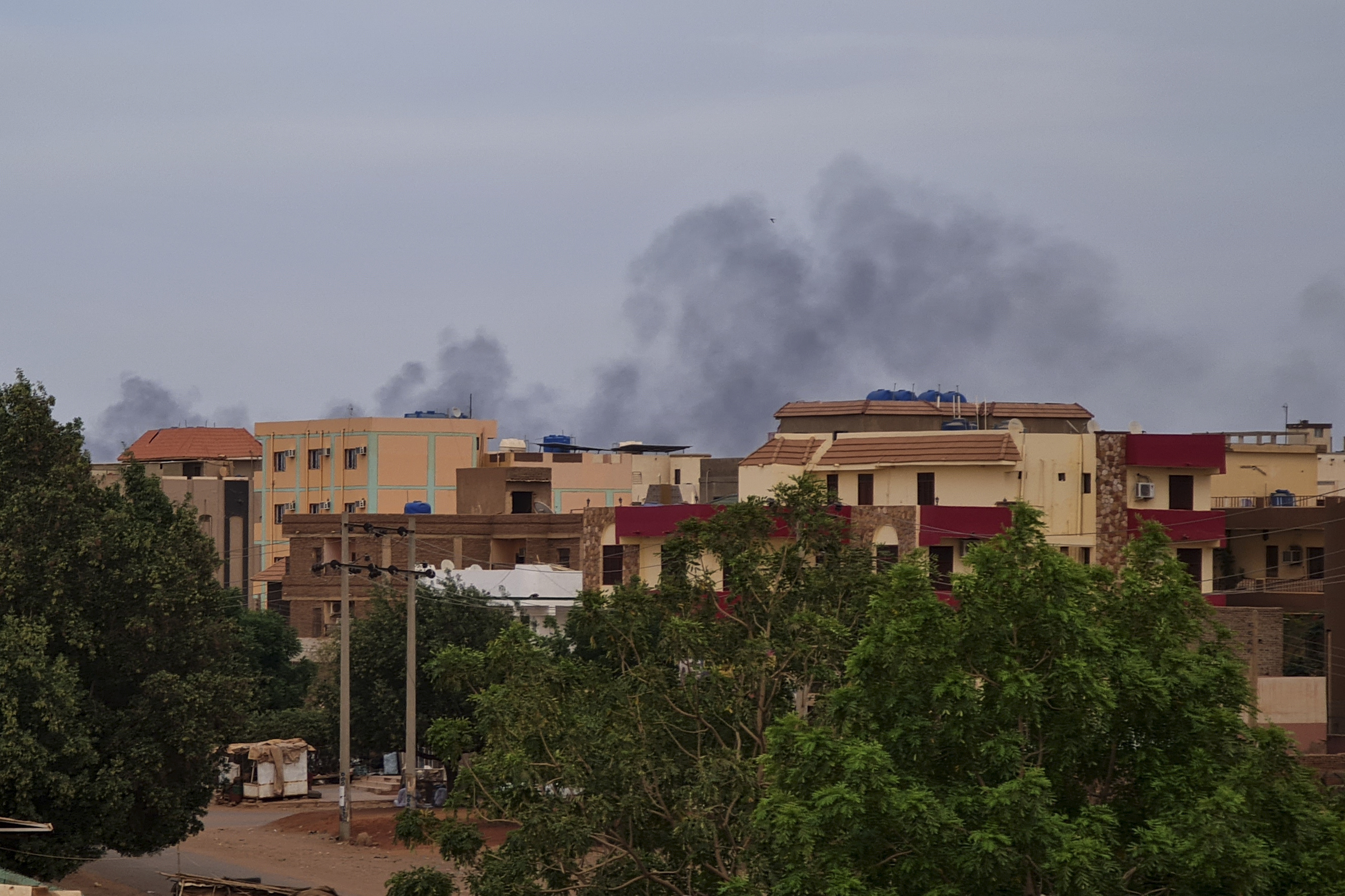 Smoke billows over residential buildings in Khartoum on April 30, 2023 as deadly clashes between rival generals' forces have entered their third week. - Heavy fighting again rocked Sudan's capital as tens of thousands have fled the bloody turmoil and a former prime minister warned of the "nightmare" risk of a descent into full-scale civil war. (Photo by - / AFP)