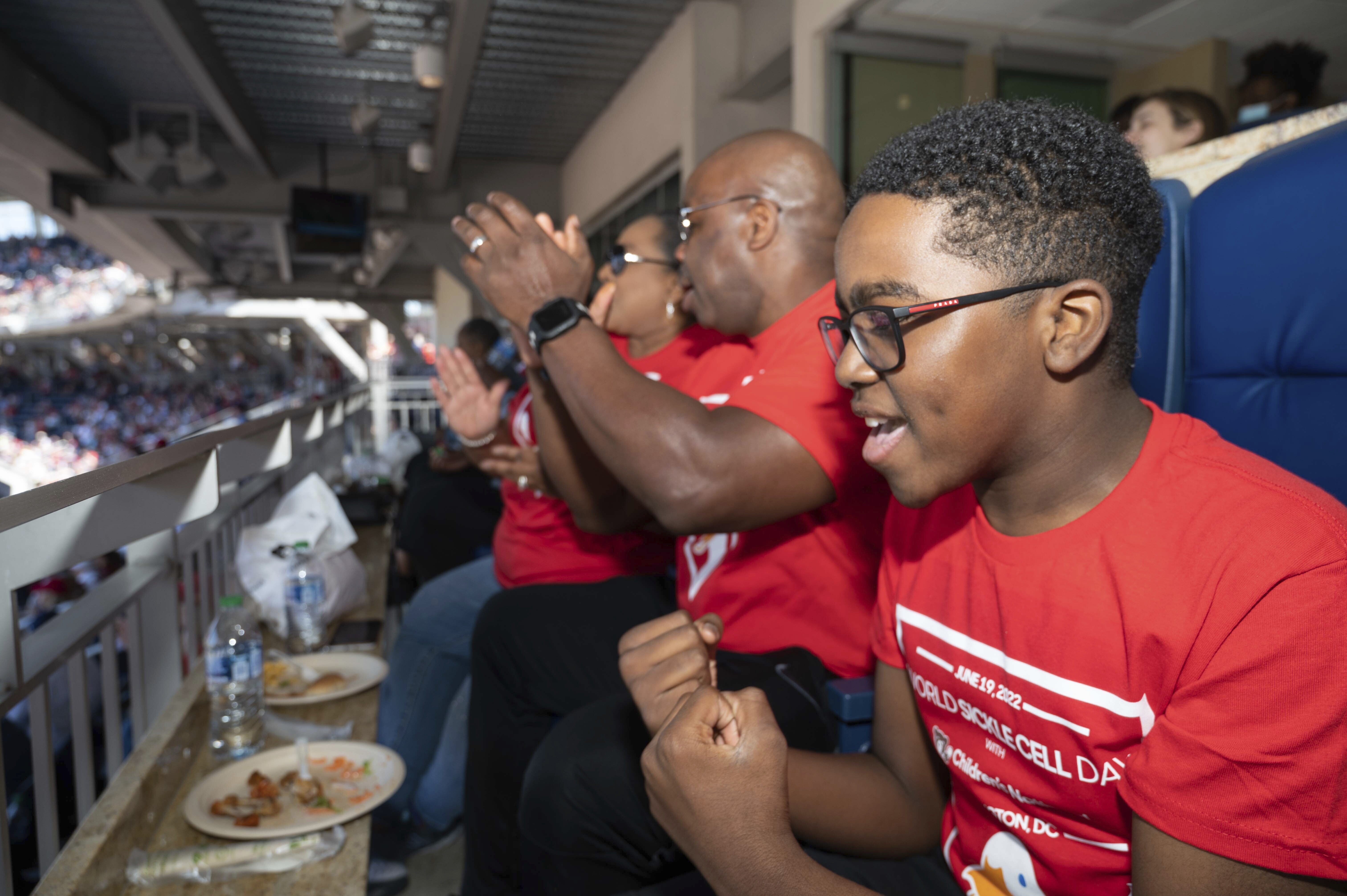 IMAGE DISTRIBUTED FOR AFLAC - Ten-year-old sickle cell patient at Children's National Hospital Kendric Comer celebrates the home team at Nationals Park at Aflac's celebration of World Sickle Cell Day, Sunday, June 19, 2022 in Washington. (Kevin Wolf/AP Images for Aflac)