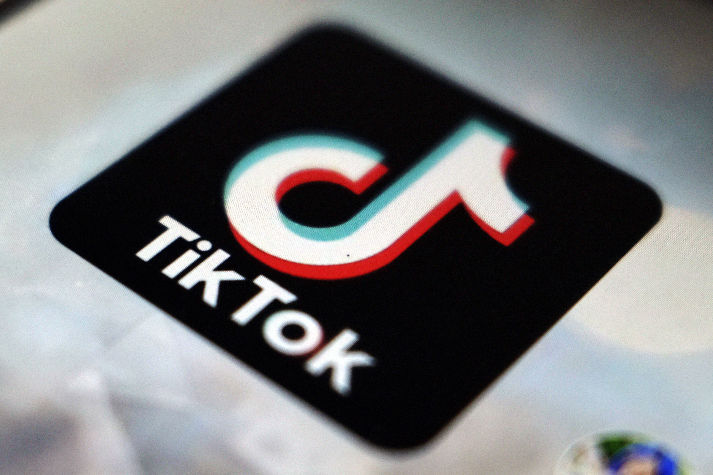 A close-up of the black TikTok logo, with its variation on a musical note