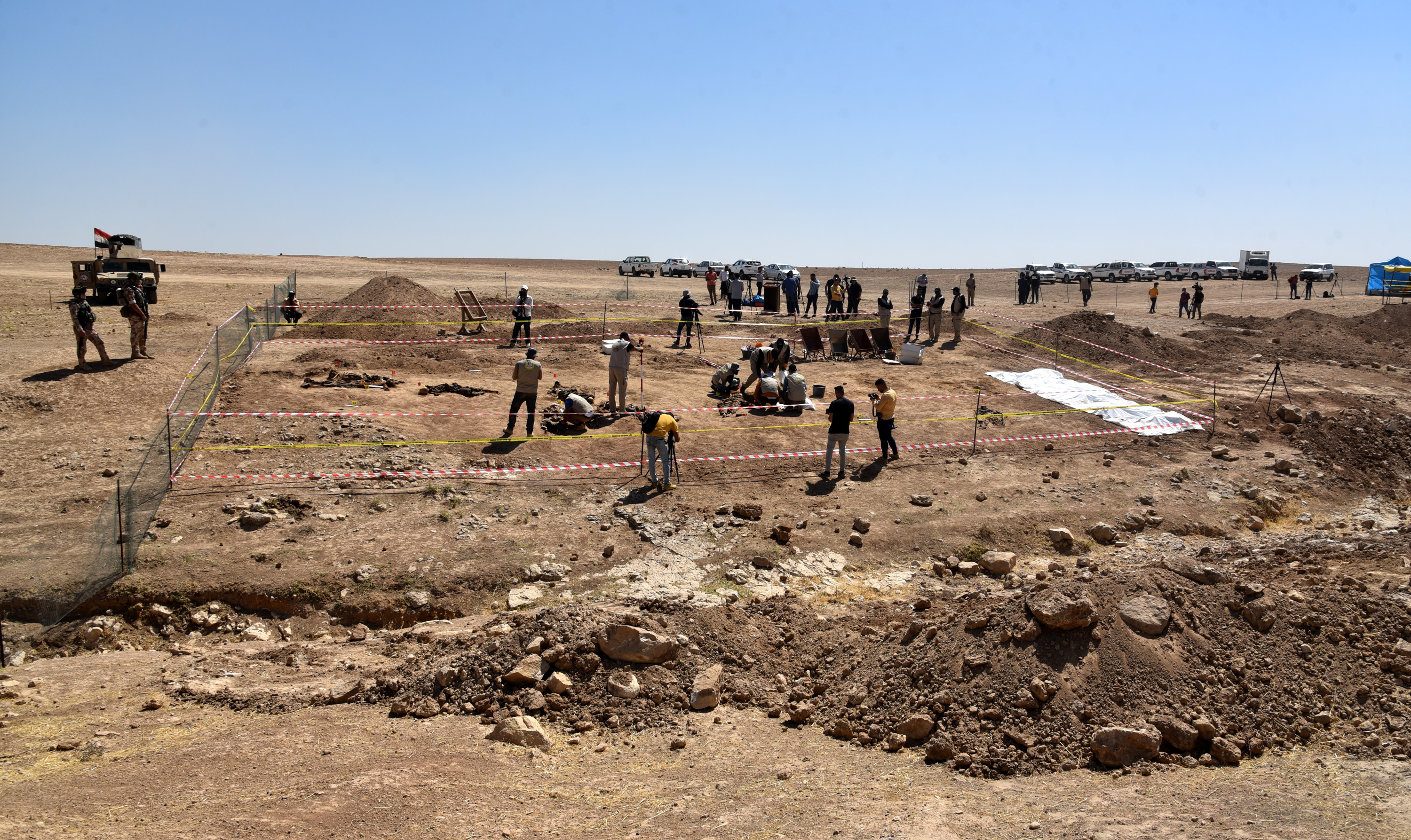 epa09267156 Iraqi forensic personnel inspect a site believed to be a mass grave in the Al-Humaydat village, western Mosul city, 500 km north of Baghdad, Iraq, 13 June 2021. Nineveh's Governor, Najm Al-Jubouri announced that "Two mass graves containing about 550 bodies of victims killed and buried by the so-called Islamic State (IS) group, have been found near the Government Badush prison in Mosul, and victims might be the personnel in charge of the prison security among them women". Badush prison was attacked by IS in June 2014, some 650 Shiite inmates had been killed, the authorities knew of the grave since 2017 when local inhabitants indicated its existence, but wanted to make sure to have the necessary forensic teams capacity to properly identify the victims. Mosul region was under IS control between 2013 and 2017. EPA-EFE/AMMAR SALIH