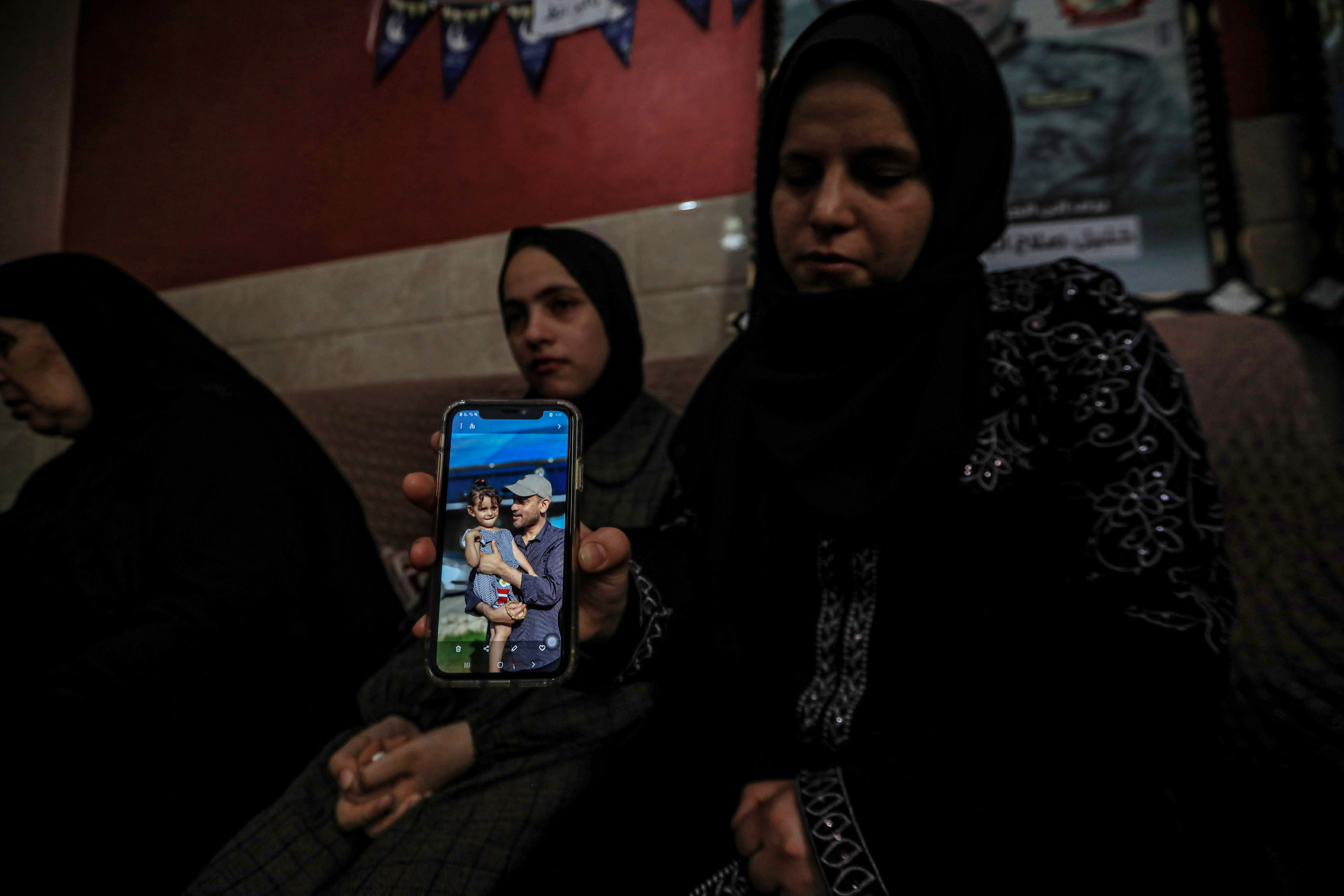 A woman crying hold a photo