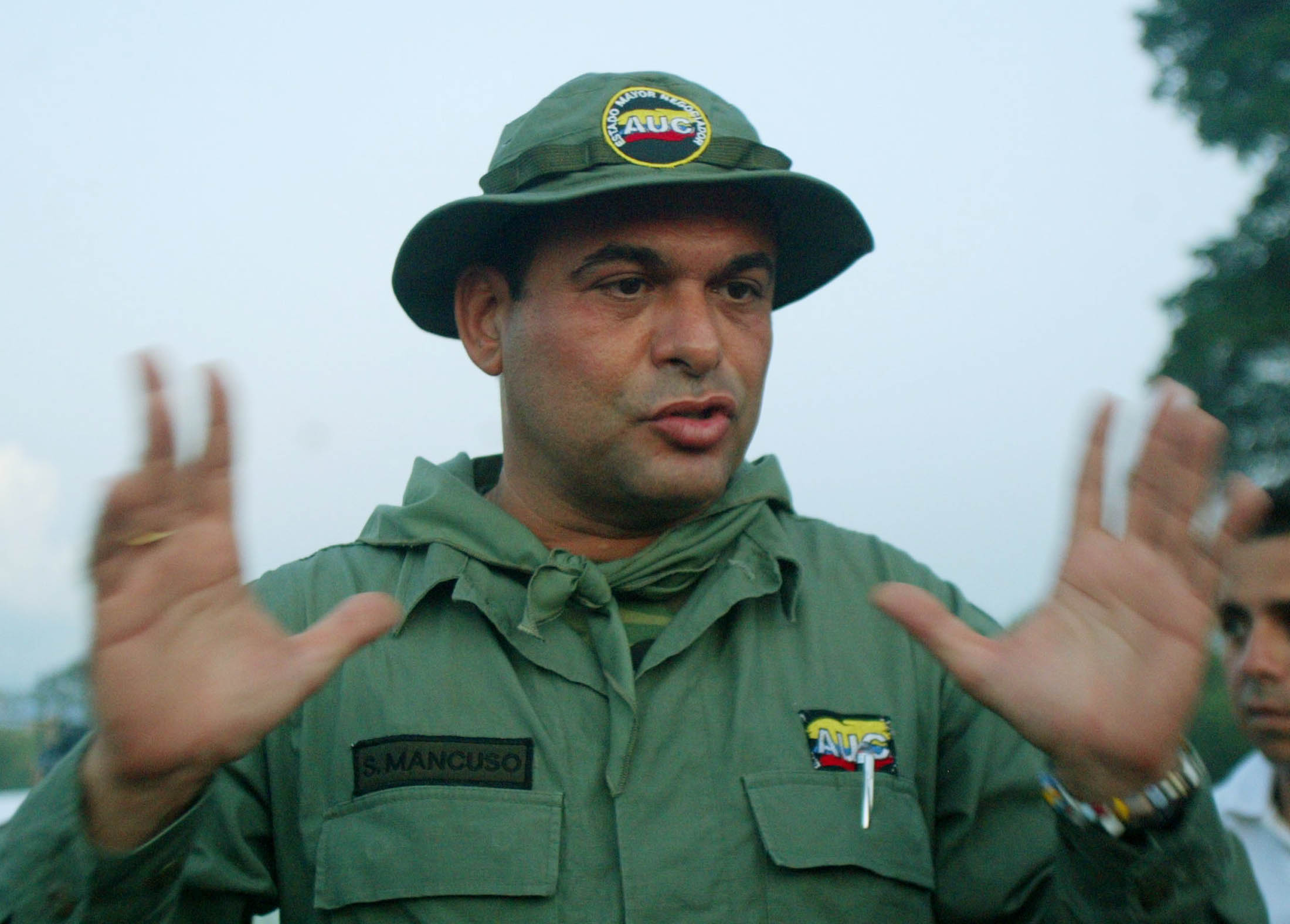 Salvatore Mancuso, the top commander of far-right Colombian paramilitaries, talks to the media in Campo Dos, Colombia, on December 9, 2004