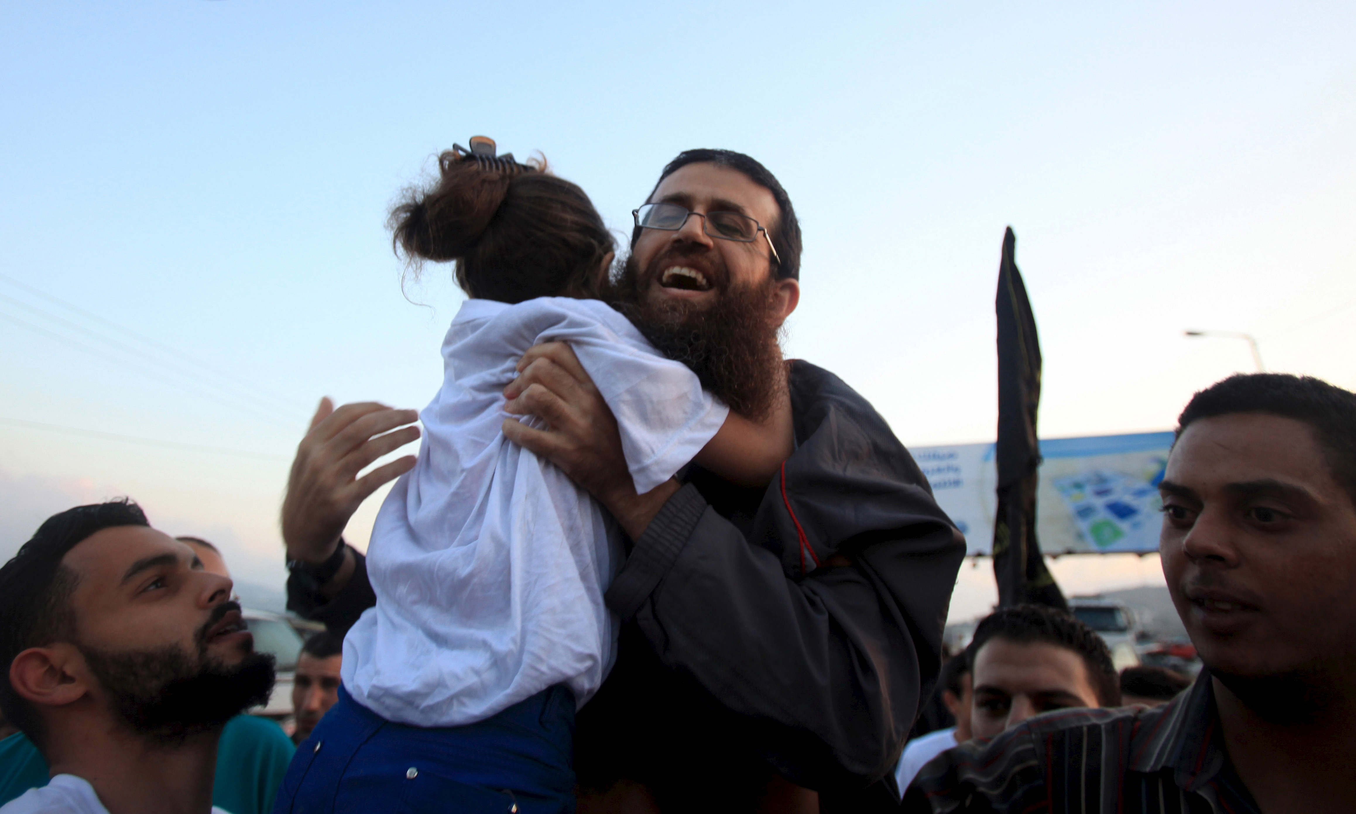 IKhader Adnan is hugged by his daughter upon his release from an Israeli jail, in the West Bank village of Arabeh near Jenin July 12, 2015.