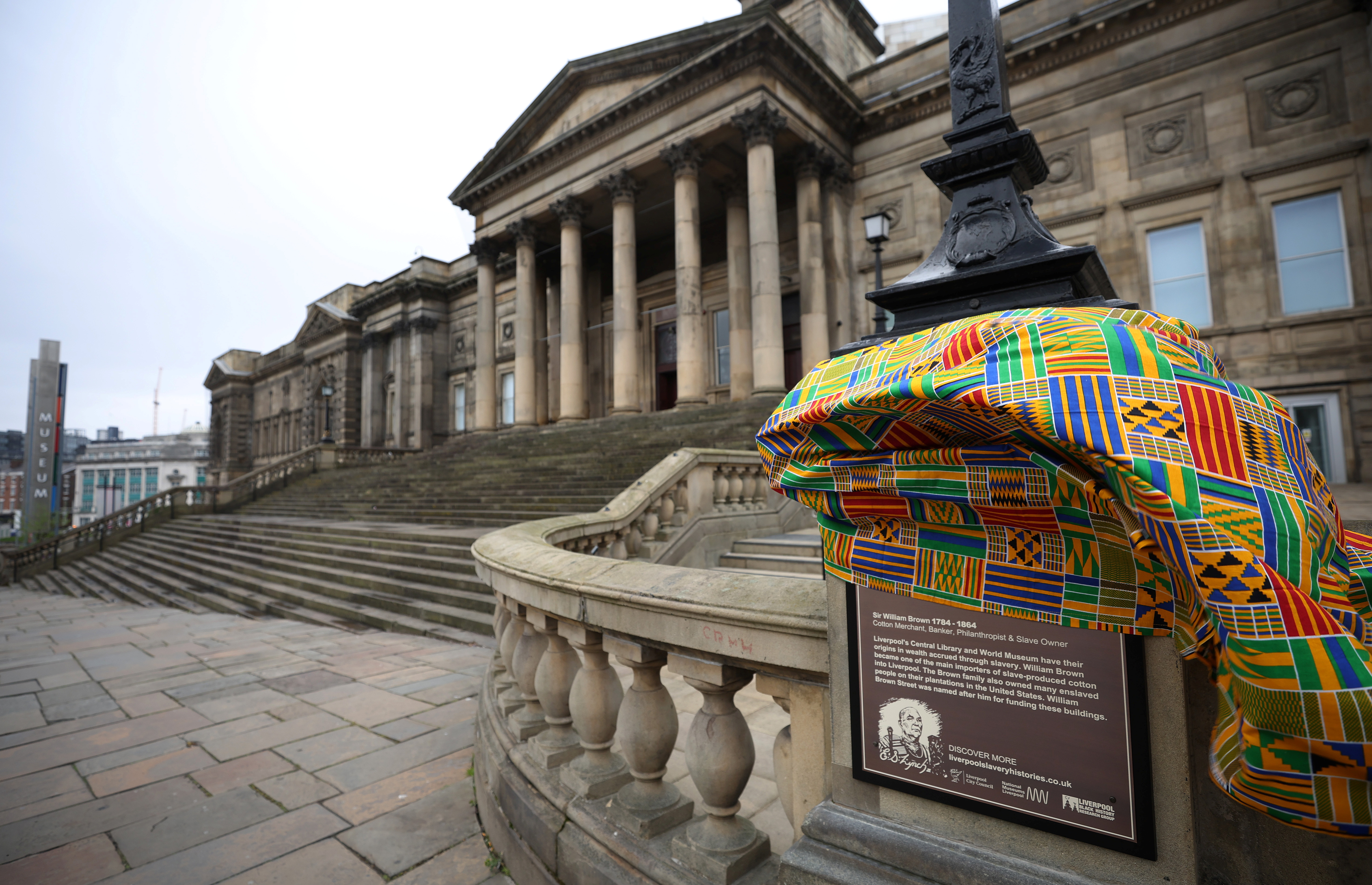 Traditional African Kente Cloth covers a newly installed plaque, explaining the links to the street name and the slave trade is seen outside the World Museum in Liverpool, Britain, April 5, 2022.