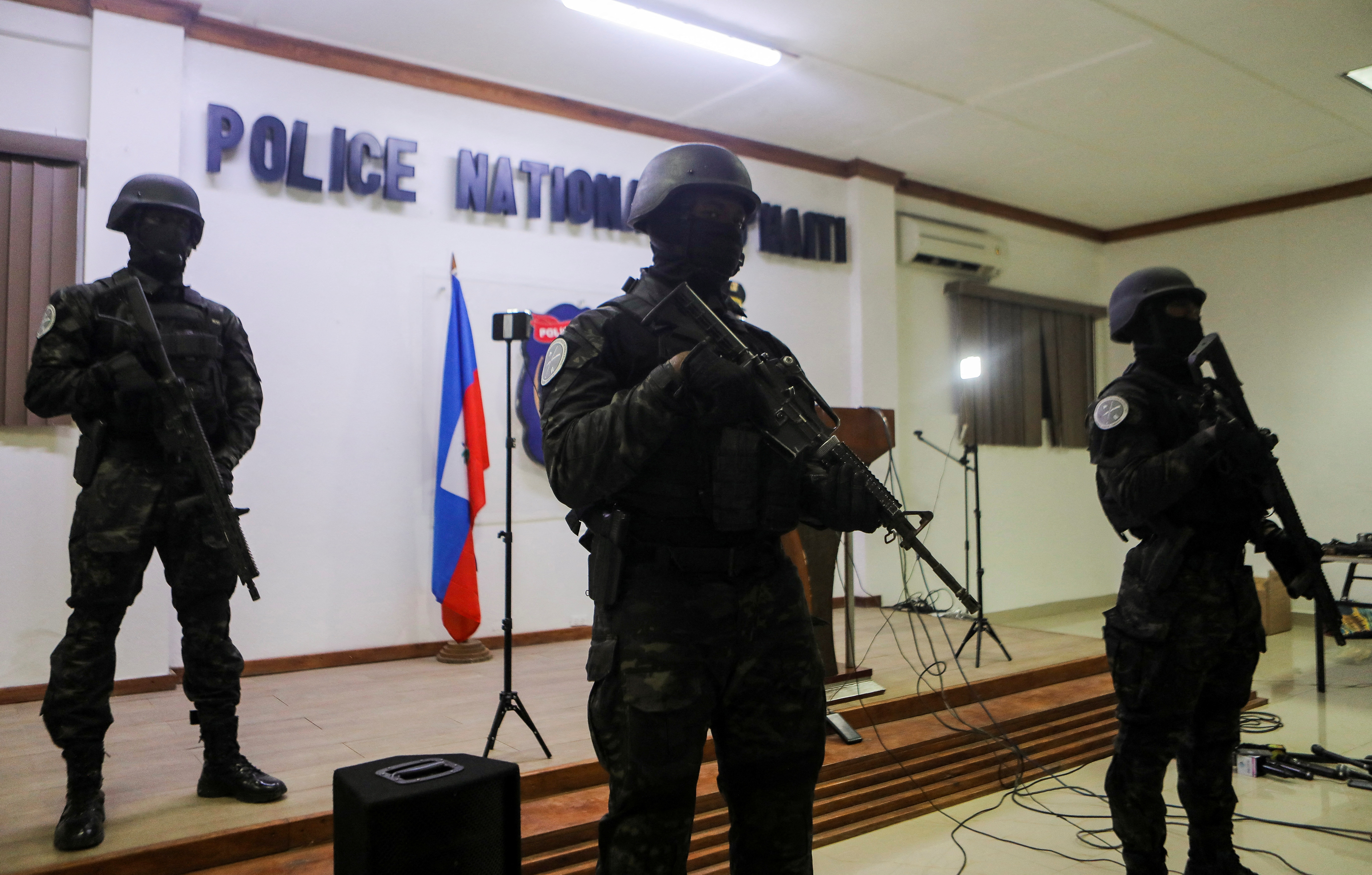 Members of the Haitian National Police stand guard during a news conference