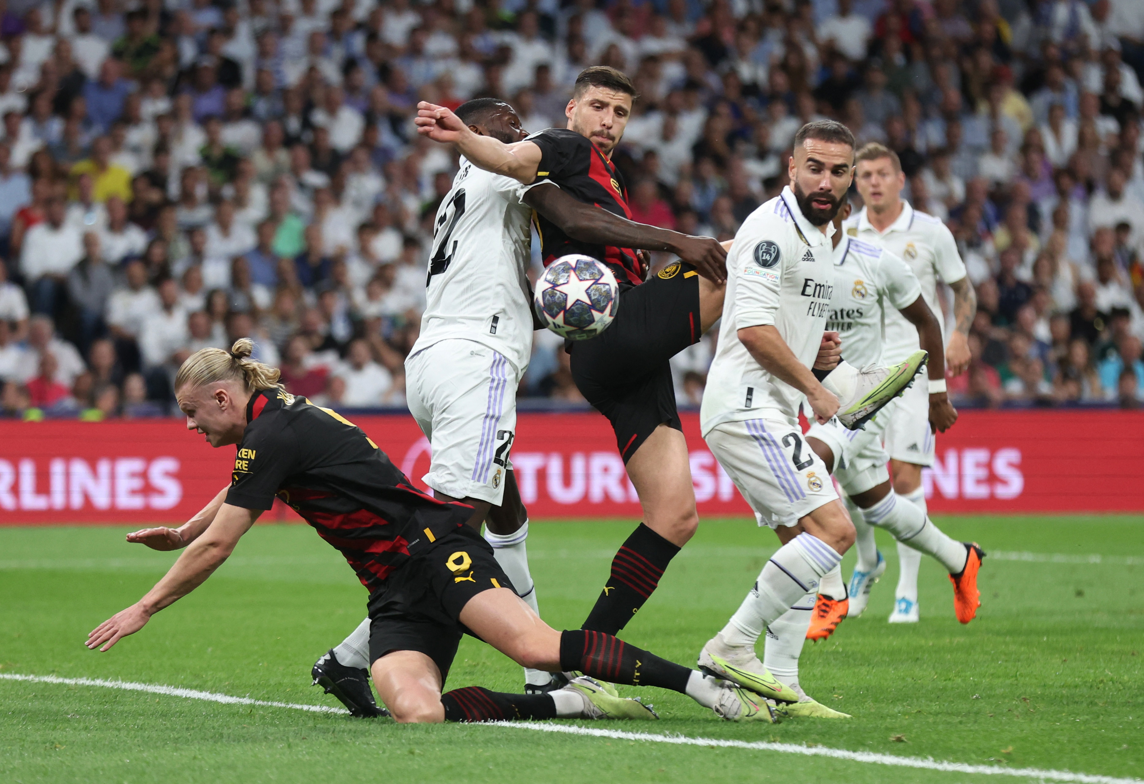 Antonio Rudiger and Dani Carvajal in action with Manchester City's Ruben Dias and Erling Braut Haaland