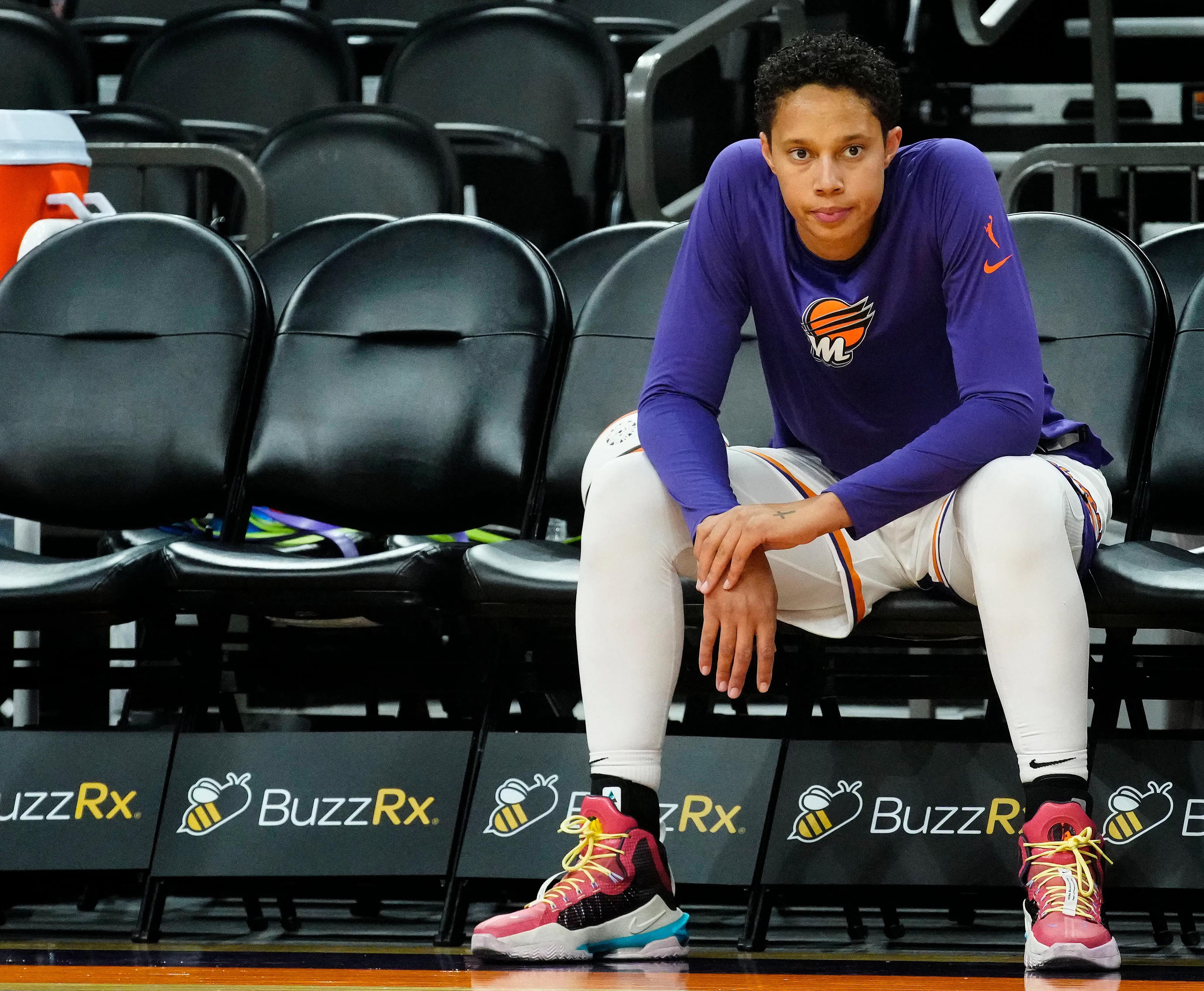 Brittney Griner sits on a bench ahead of a pre-season WNBA game with the Phoenix Mercury
