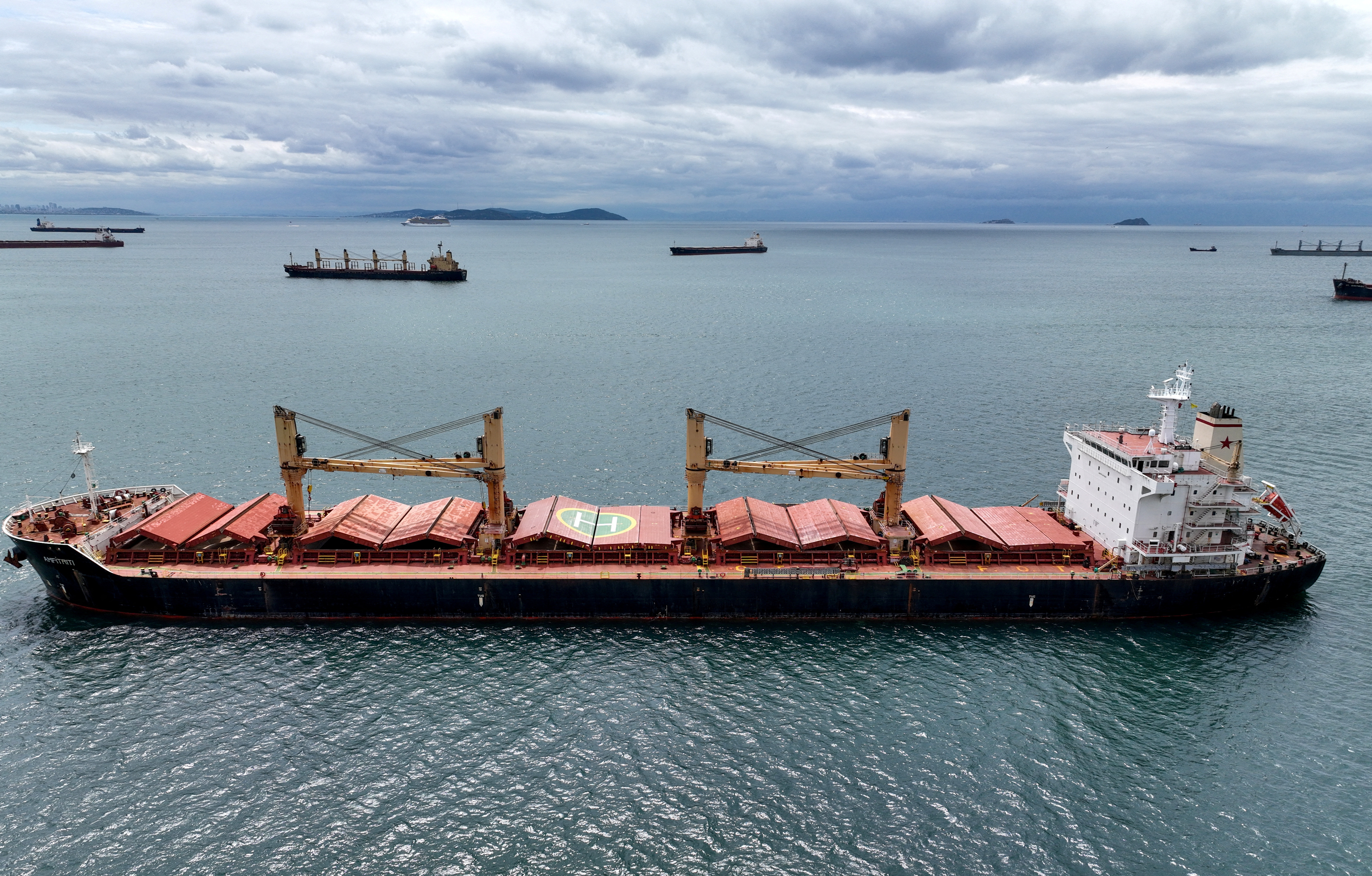 FILE PHOTO: Amfitriti, a bulk carrier part of the Black Sea grain deal, and other commercial vessels wait to pass the Bosphorus strait off the shores of Yenikapi in Istanbul