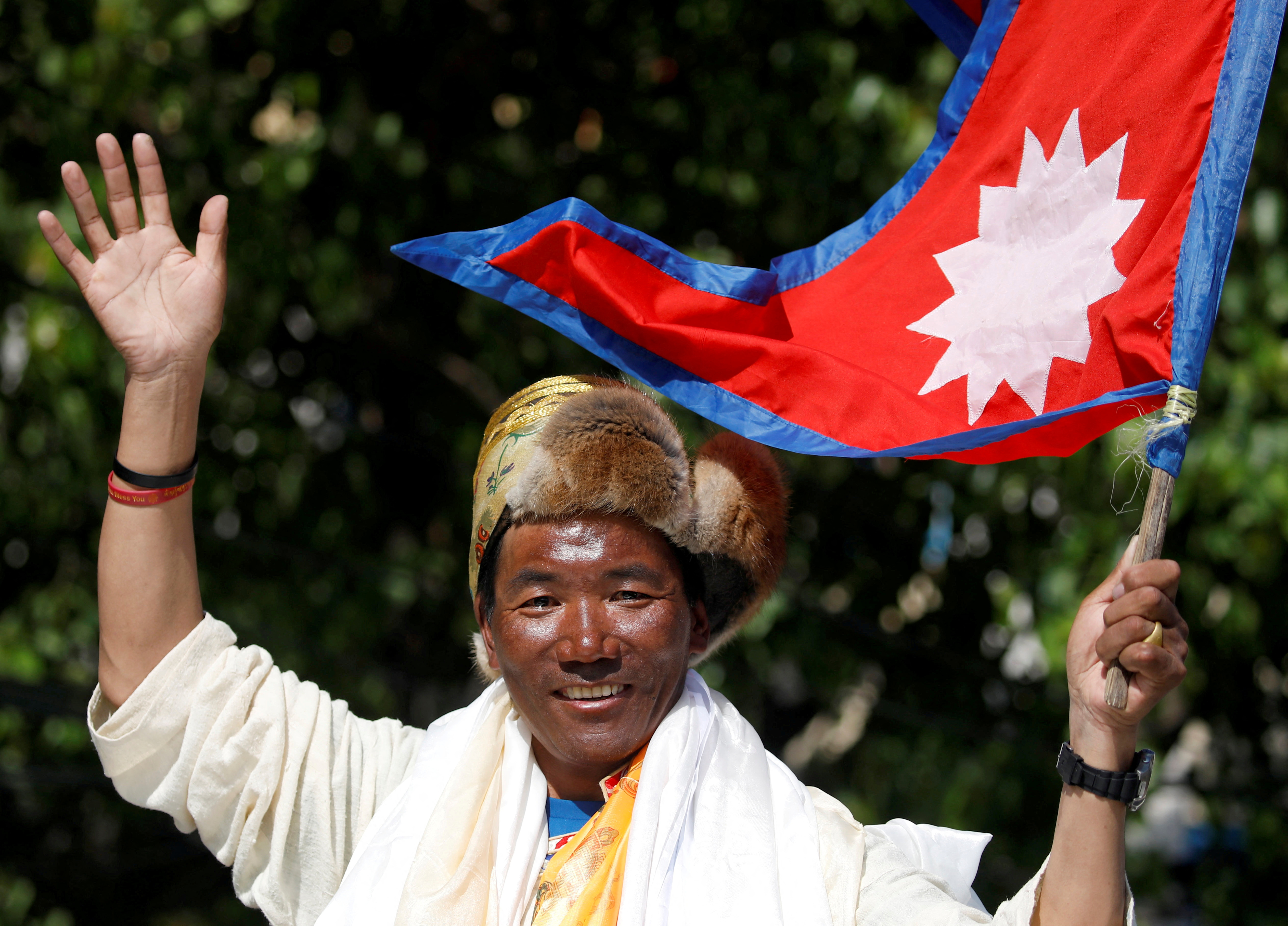 Nepali mountaineer Kami Rita Sherpa waves upon his arrival after climbing Mount Everest for the 24th time in 2019, setting a record for the most summits of the world's highest mountain, in Kathmandu, Nepal