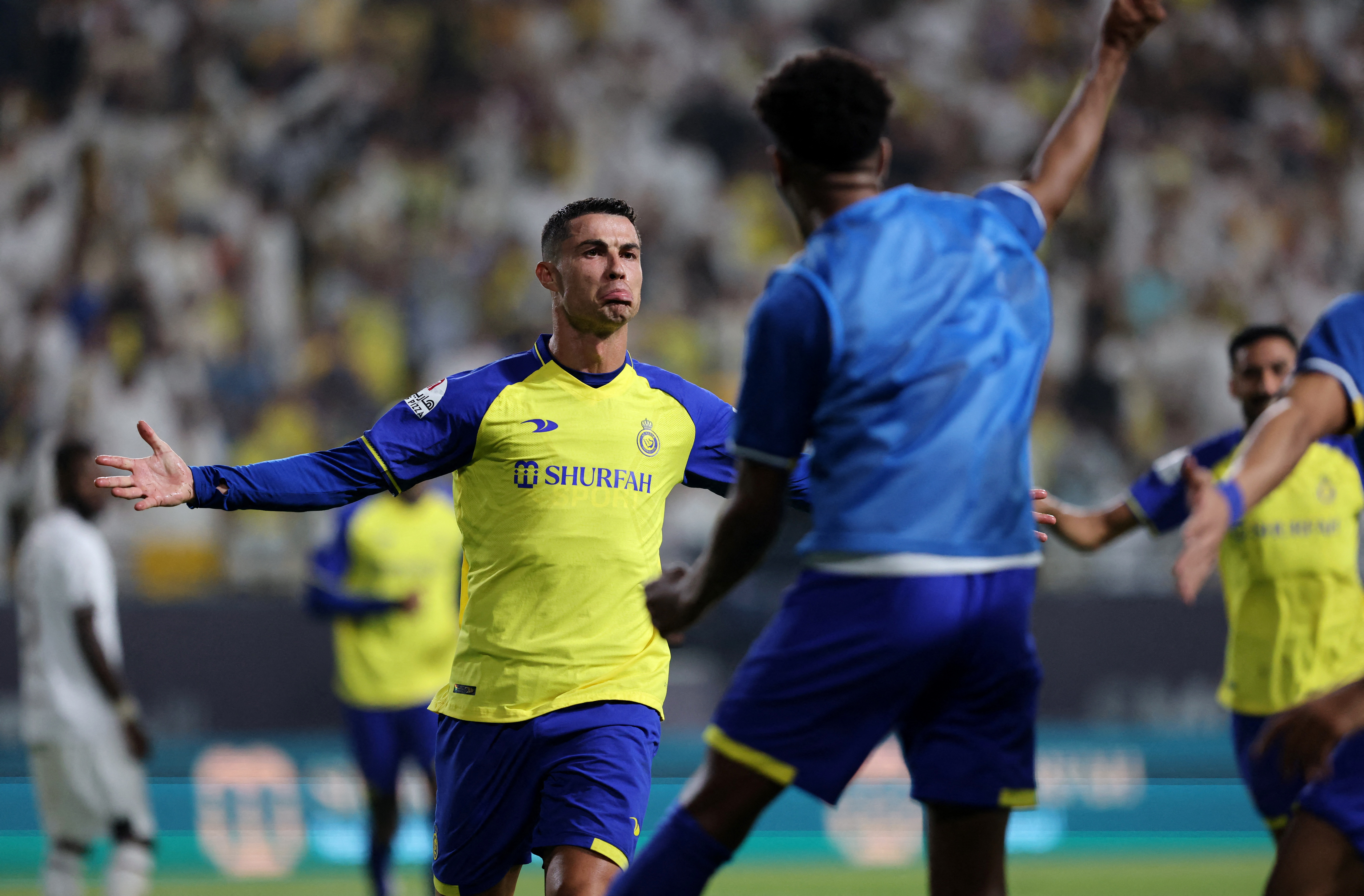 Cristiano Ronaldo spreads his arms as he plays for Al Nassr