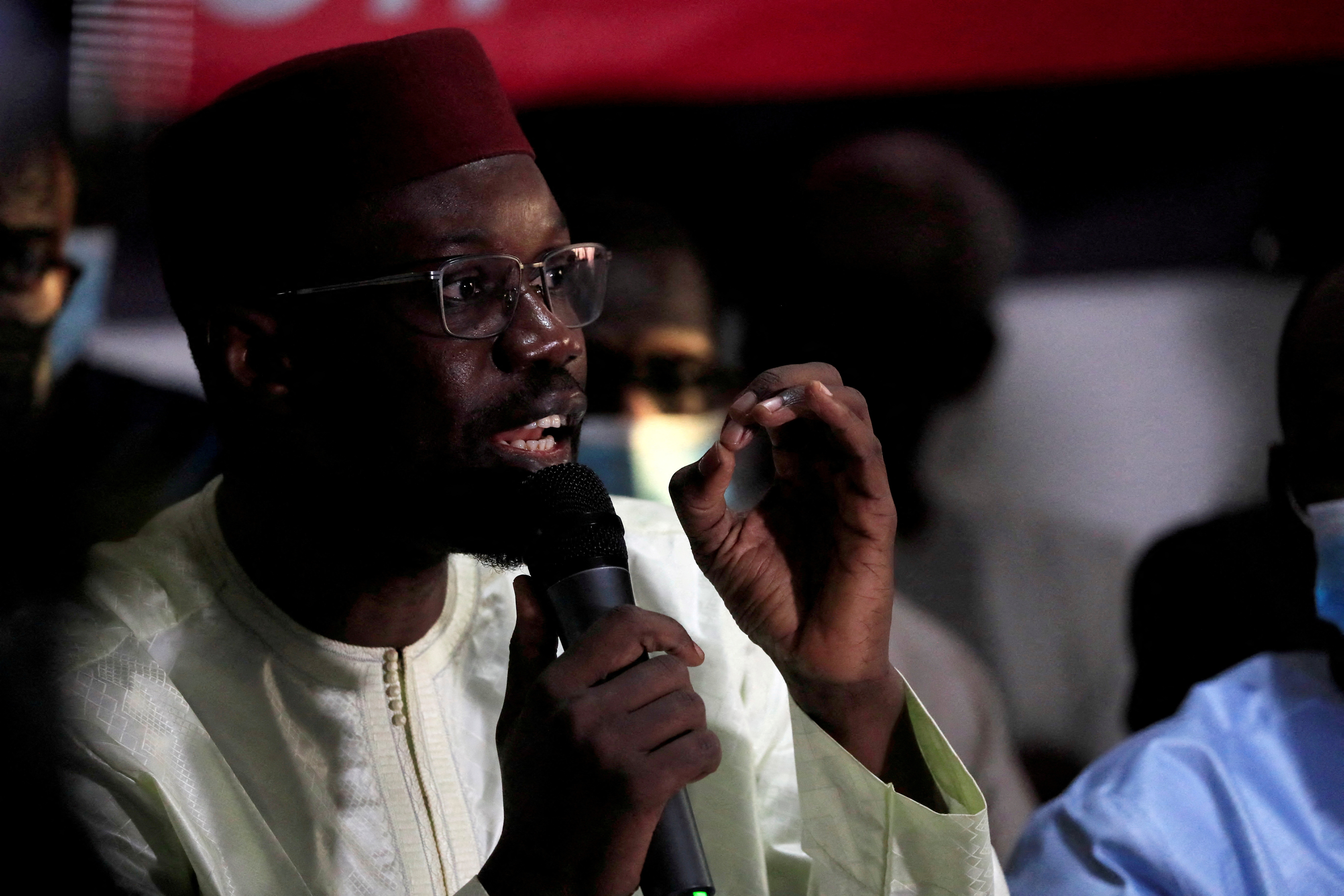Ousmane Sonko, dressed in white, speaks during a news conference in Dakar, Senegal March 8, 2021