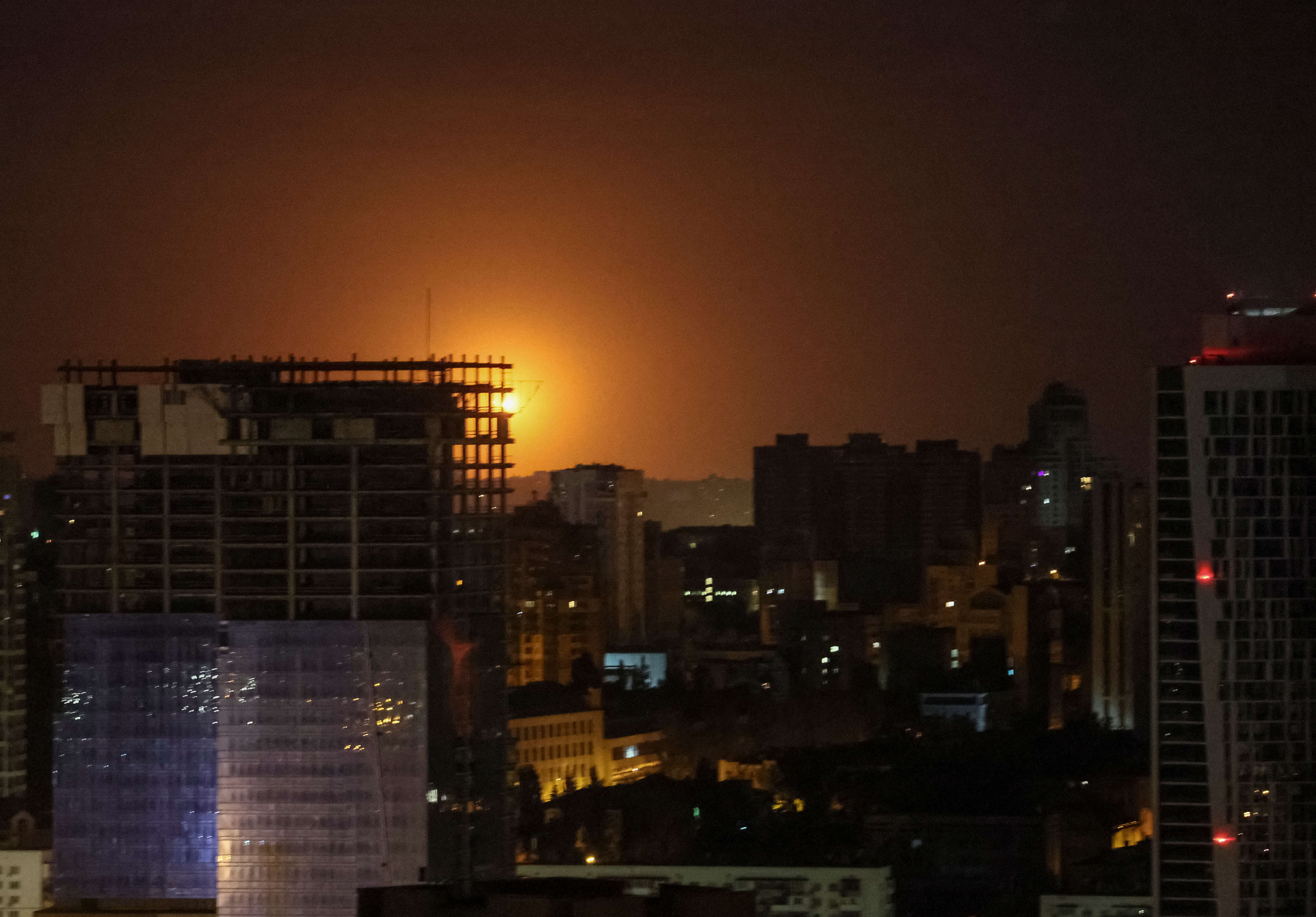 An explosion of a drone is seen in the sky over Kyiv during a Russian drone strike on May 28, 2023