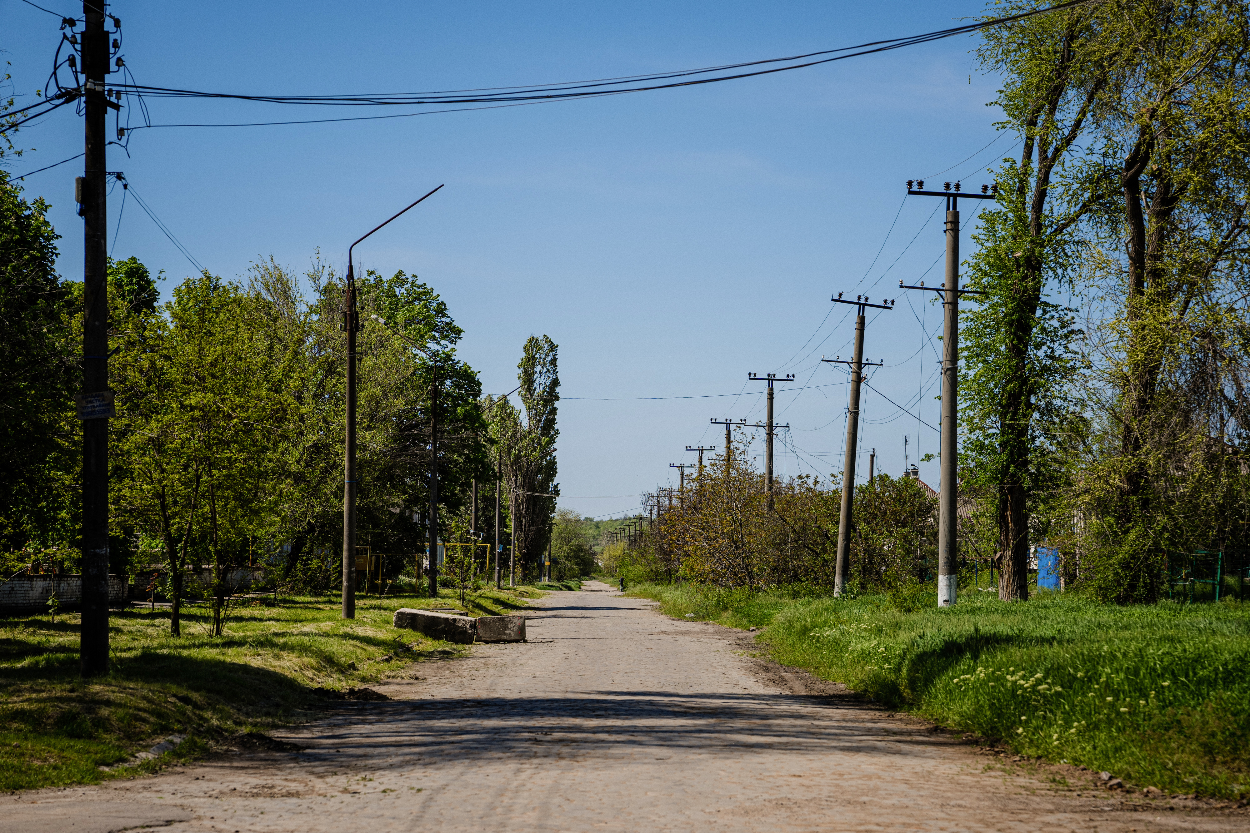 Local residents sit in a volunteer run shelter, providing access to laundry and bathroom facilities where they can warm up, charge their phones, drink hot tea and receive humanitarian aid in the town of Orikhiv, in the Zaporizhzhia region