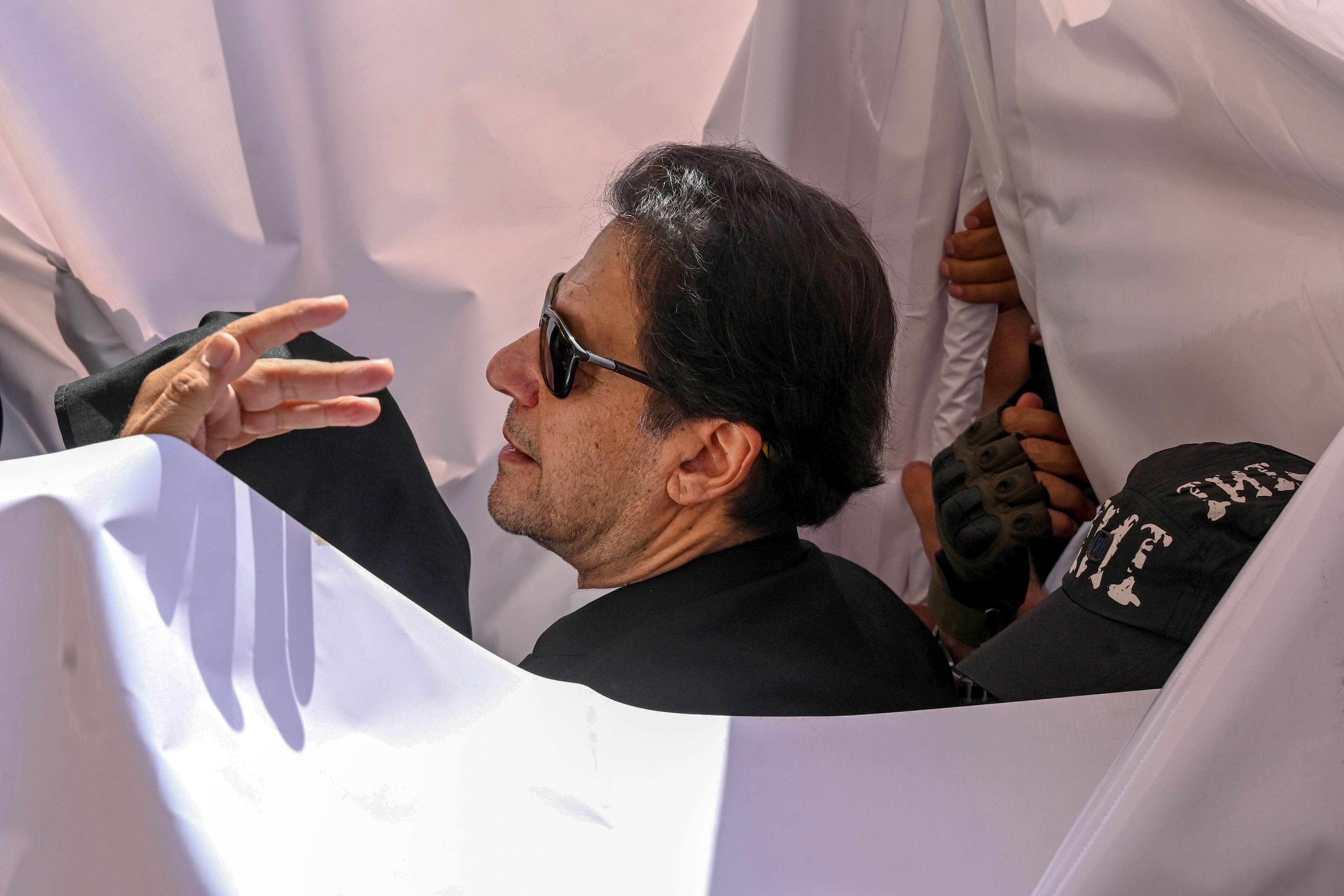 Former Pakistan prime minister Imran Khan (C) arrives to appear at a high court in Lahore