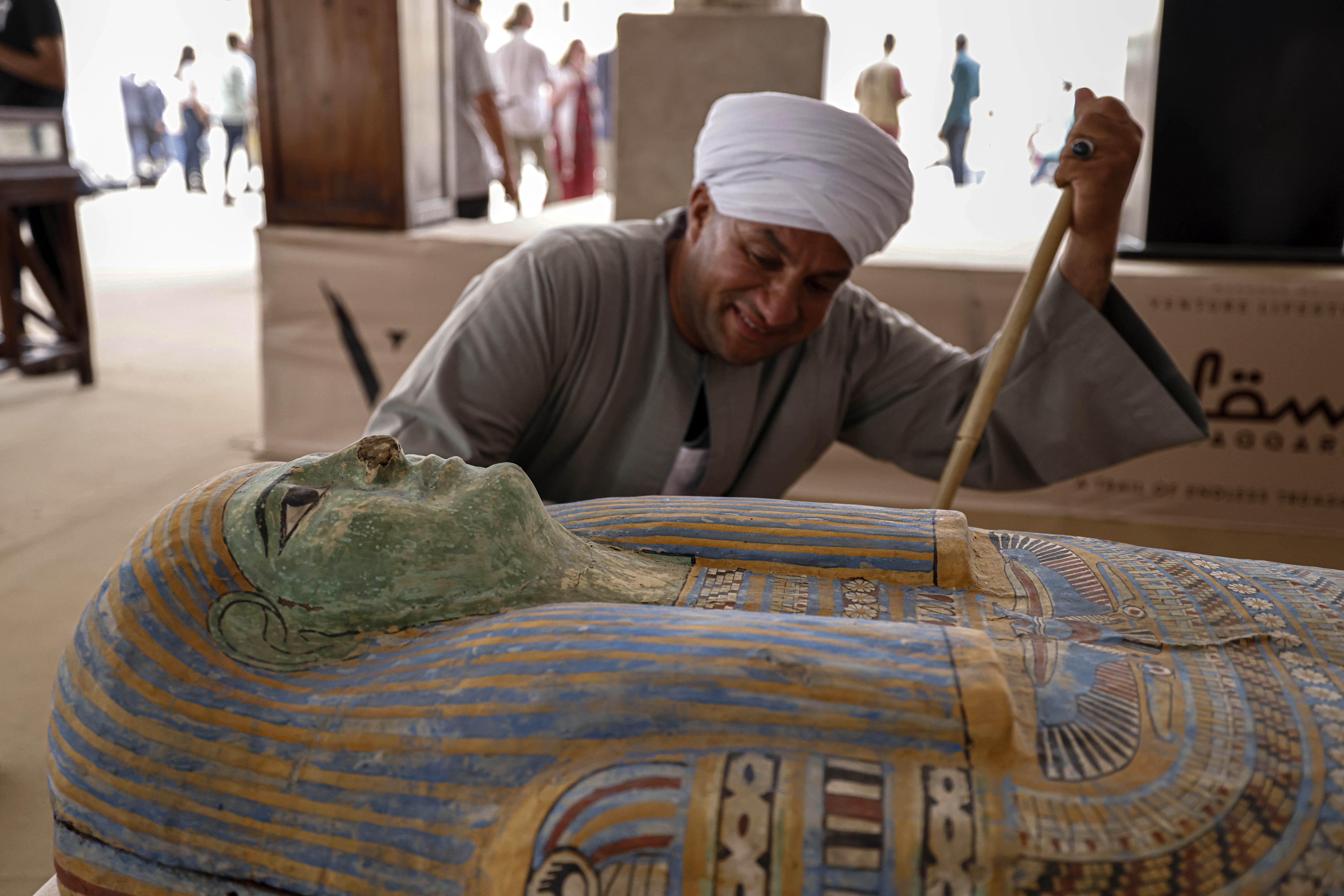 Mostafa Abdo Sadek, the overseer of diggers,observes a newly discovered sarcophagus in the Saqqara necropolis